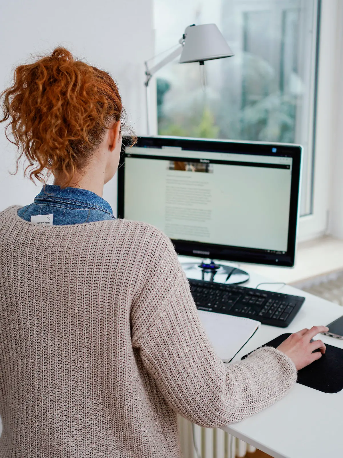 ARCHIV - 22.01.2021, Baden-Württemberg, Mannheim: Eine Frau arbeitet in ihrer Wohnung vor einem Computer an einem Stehtisch. (zu dpa "Eigener Schreibtisch in Gefahr - Tücken für Unternehmen") Foto: Uwe Anspach/dpa +++ dpa-Bildfunk +++