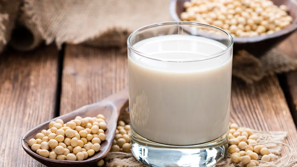 Glass with Soy Milk and Seeds on wooden background