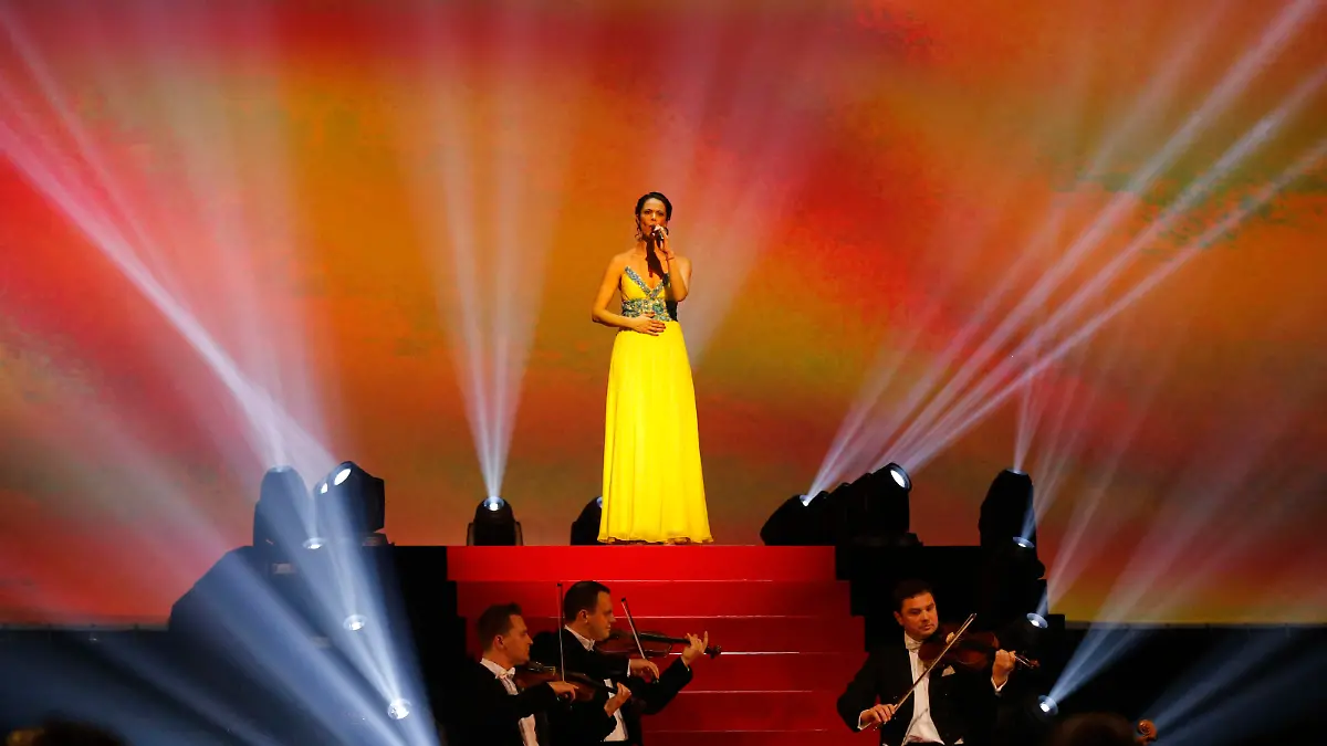 Natalia Klitschko, wife of Ukranian politician Vitali Klitschko, sings the Ukrainian national anthem before the heavyweight title bout between IBF, WBA, WBO and IBO champion Wladimir Klitschko from Ukraine and his Australian challenger Alex Leapai in Oberhausen, western Germany, Sunday, April 27, 2014. (AP Photo/Frank Augstein)