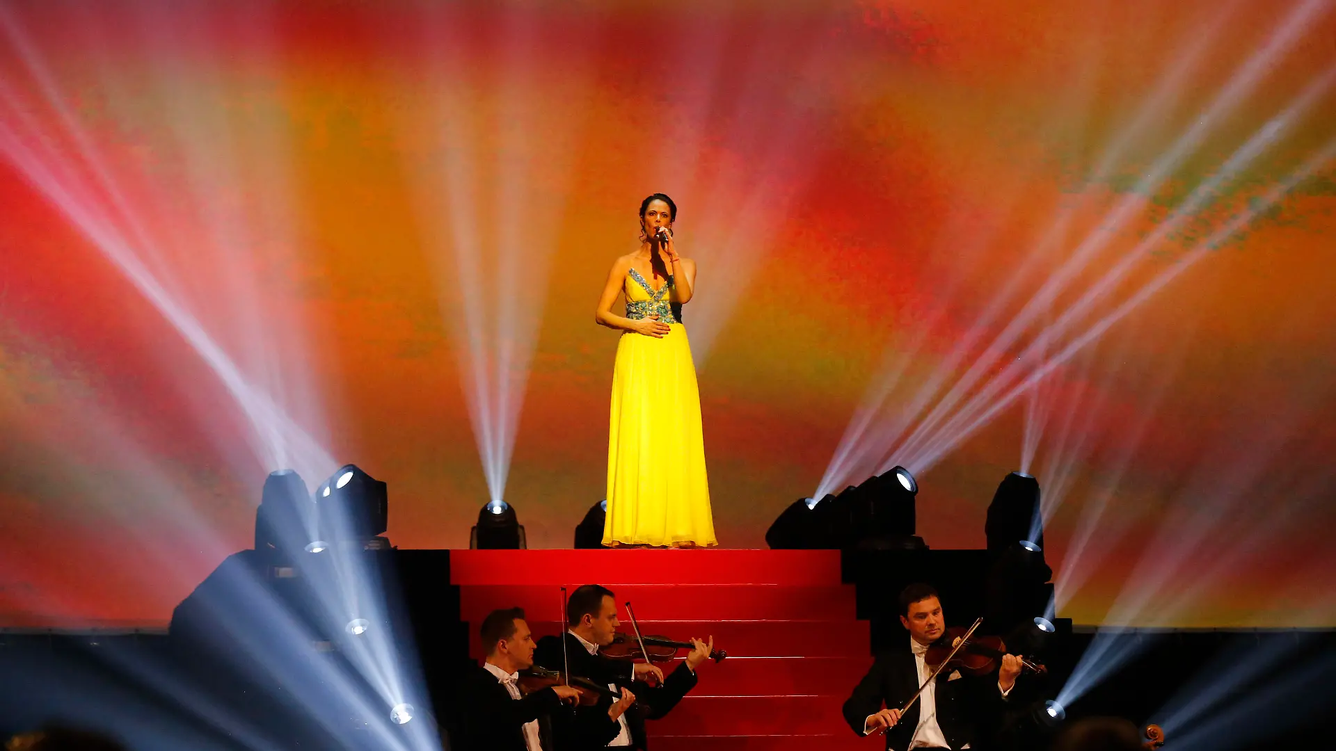 Natalia Klitschko, wife of Ukranian politician Vitali Klitschko, sings the Ukrainian national anthem before the heavyweight title bout between IBF, WBA, WBO and IBO champion Wladimir Klitschko from Ukraine and his Australian challenger Alex Leapai in Oberhausen, western Germany, Sunday, April 27, 2014. (AP Photo/Frank Augstein)