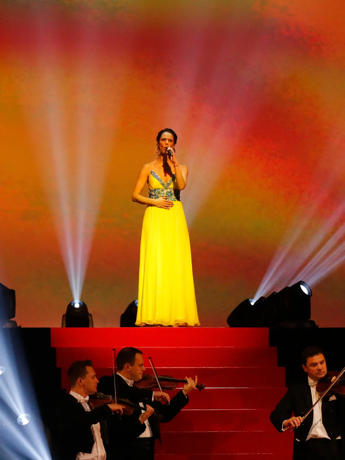 Natalia Klitschko, wife of Ukranian politician Vitali Klitschko, sings the Ukrainian national anthem before the heavyweight title bout between IBF, WBA, WBO and IBO champion Wladimir Klitschko from Ukraine and his Australian challenger Alex Leapai in Oberhausen, western Germany, Sunday, April 27, 2014. (AP Photo/Frank Augstein)