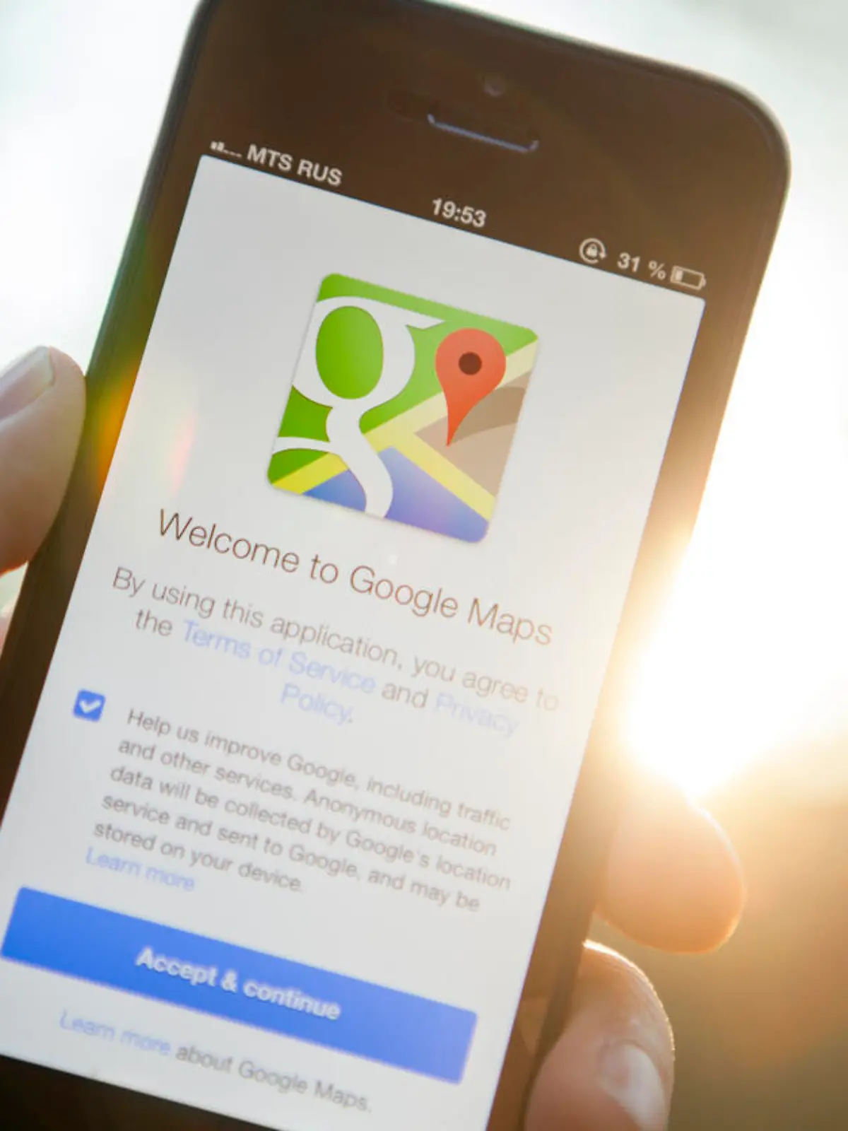 Moscow, Russia - August 29, 2013: Man hand holding iPhone 5 with Google Maps app on a sunset background. iPhone is product Apple Inc. Google Maps is a web mapping service application and technology provided by Google.