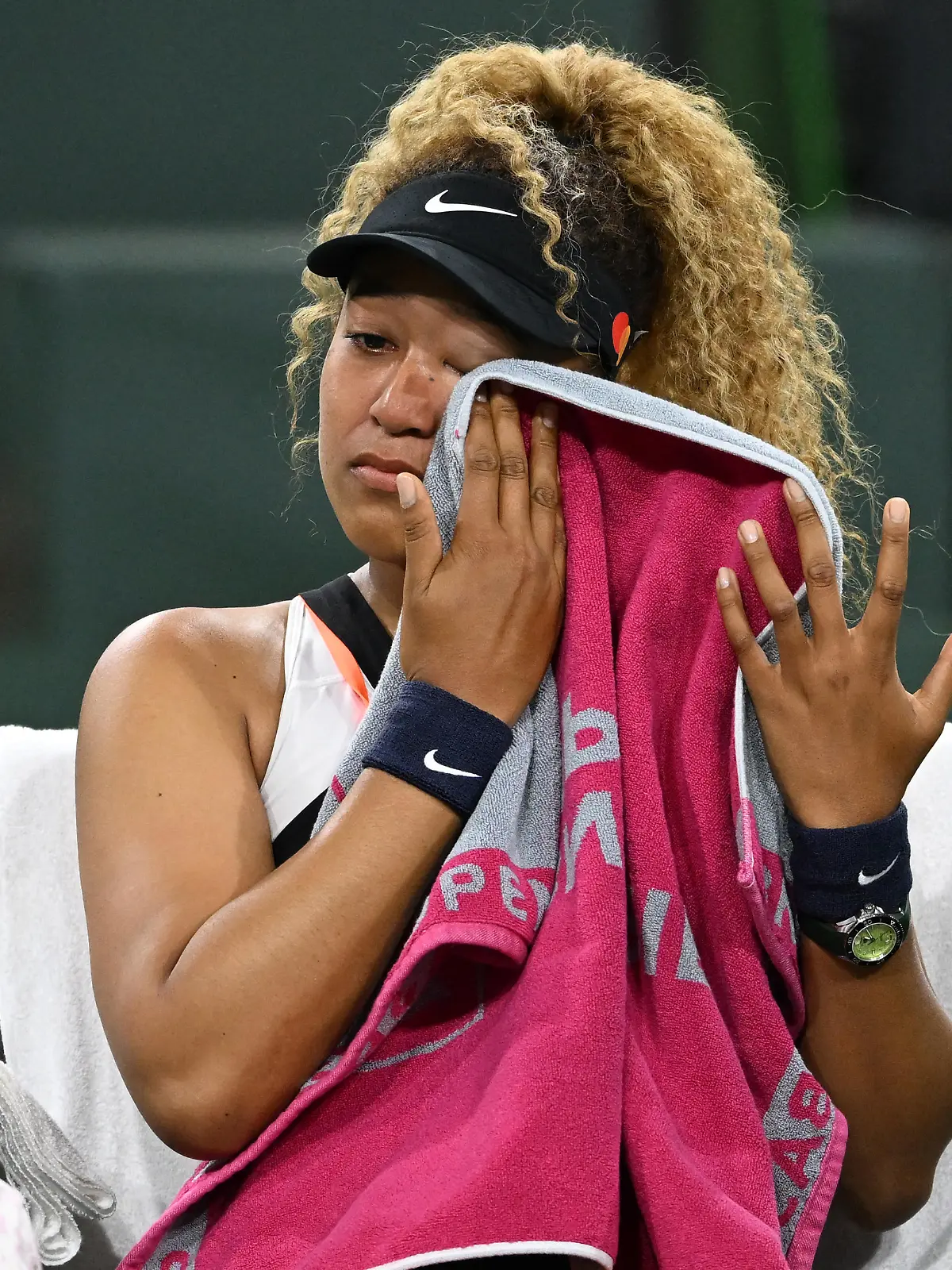 Mar 12, 2022; Indian Wells, CA, USA; Naomi Osaka (JPN) wipes her face as she talks to referee Claire Wood after a spectator disrupted play, yelling Naomi you suck, before the start of her 2nd round match against Veronika Kudermetova (RUS) at the BNP Paribas open at the Indian Wells Tennis Garden. Mandatory Credit: Jayne Kamin-Oncea-USA TODAY Sports