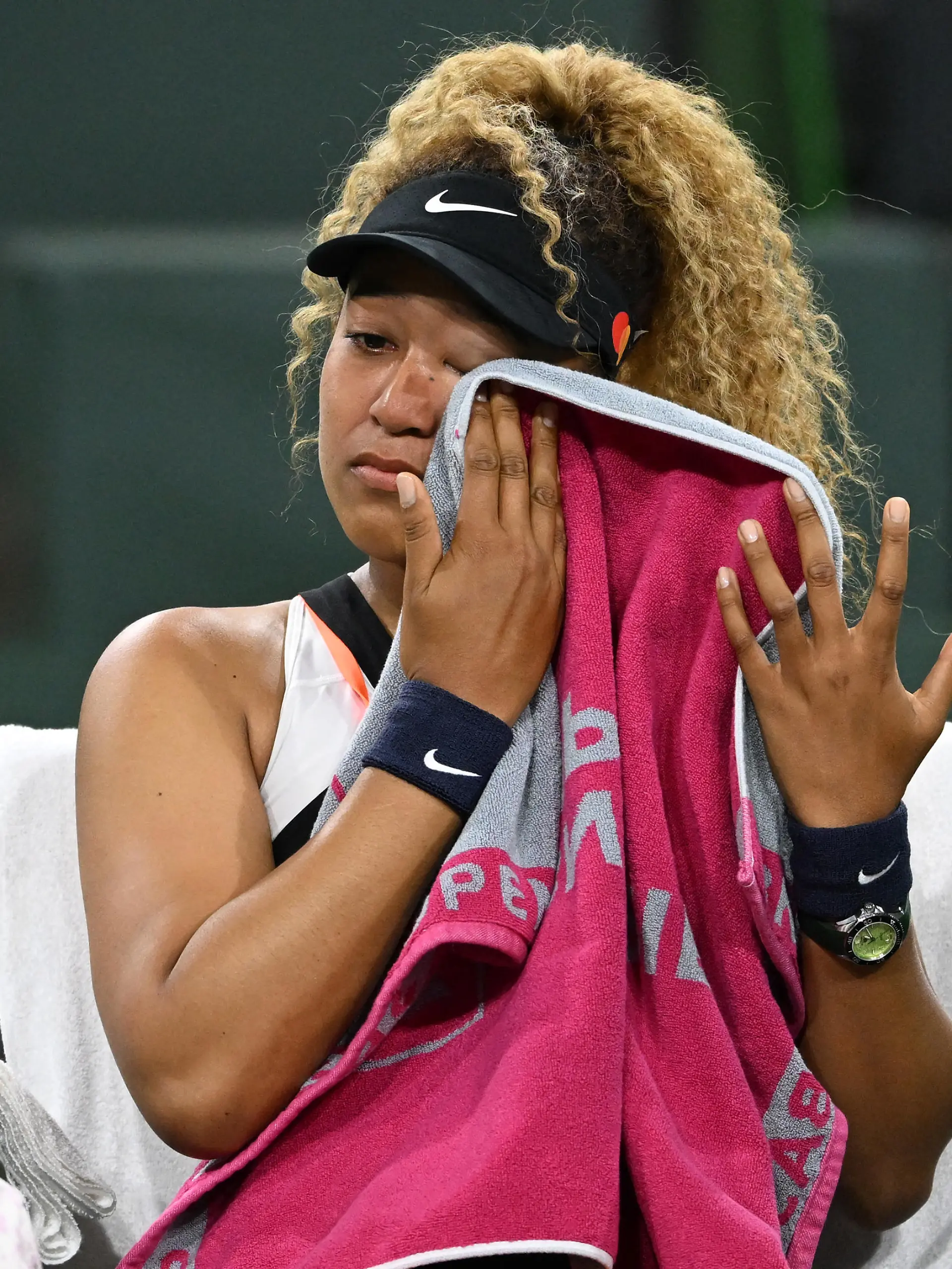 Mar 12, 2022; Indian Wells, CA, USA; Naomi Osaka (JPN) wipes her face as she talks to referee Claire Wood after a spectator disrupted play, yelling Naomi you suck, before the start of her 2nd round match against Veronika Kudermetova (RUS) at the BNP Paribas open at the Indian Wells Tennis Garden. Mandatory Credit: Jayne Kamin-Oncea-USA TODAY Sports