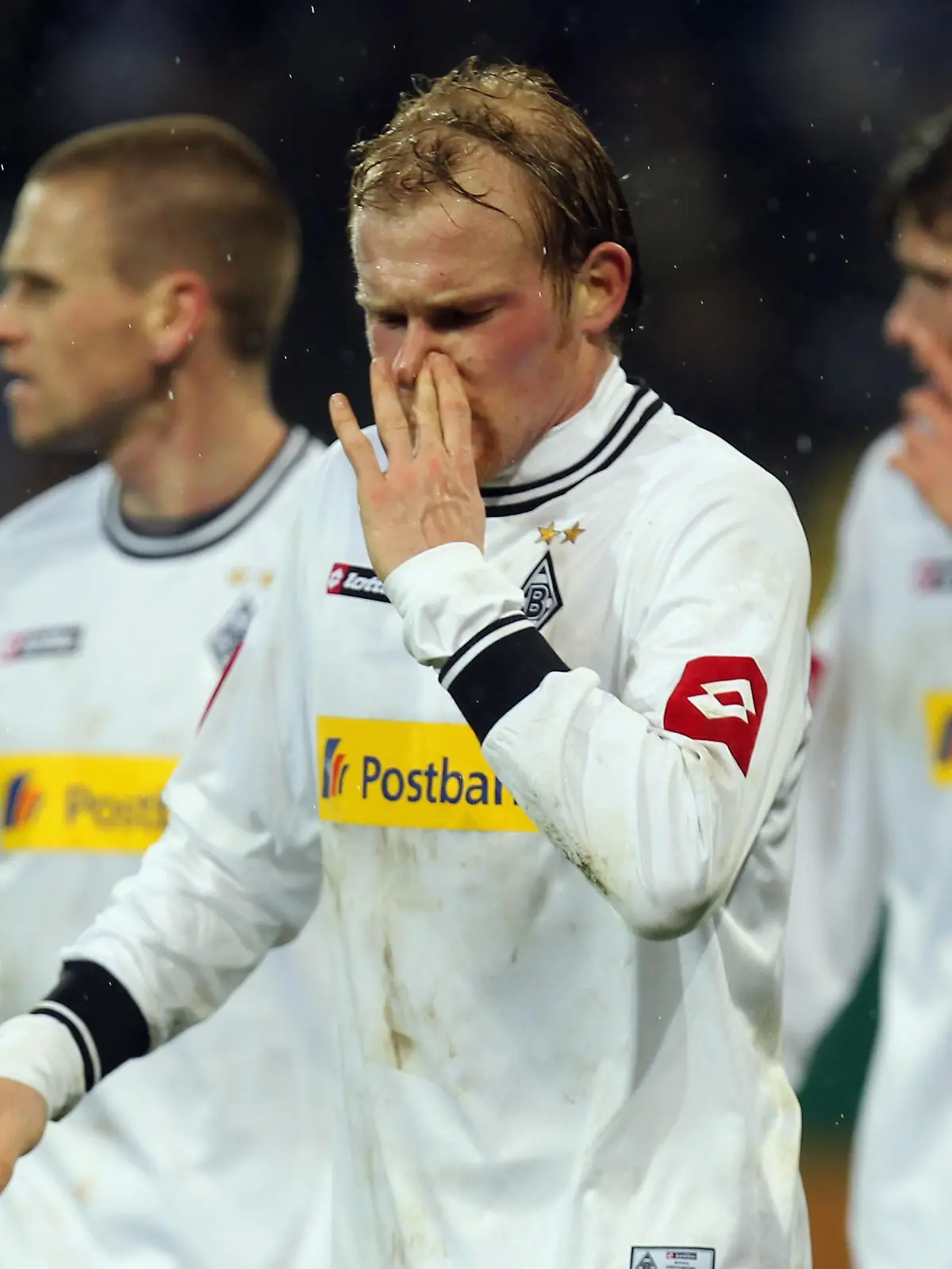 SINSHEIM, GERMANY - DECEMBER 21: Filip Daems, Tobias Levels and Roman Neustaedter (L-R) react after the DFB Cup round of sixteen match between 1899 Hoffenheim and Borussia M'Gladbach at the Rhein-Neckar Arena on December 21, 2010 in Sinsheim, Germany.  (Photo by Alex Grimm/Bongarts/Getty Images)