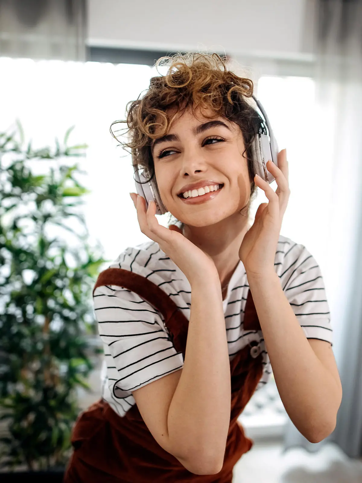 Young woman listening to music in living room