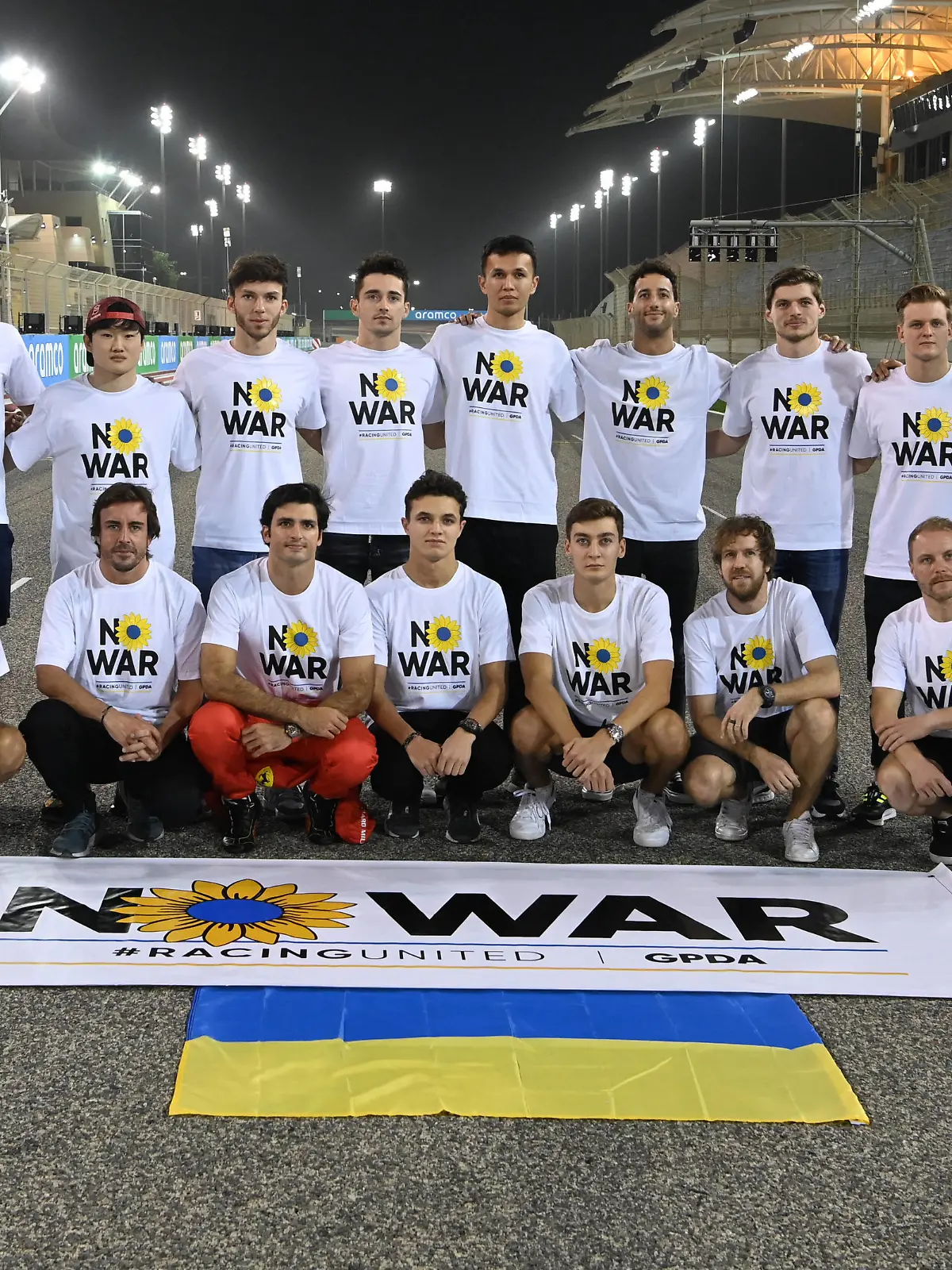 Formula 1 2022: Bahrain March Testing BAHRAIN INTERNATIONAL CIRCUIT, BAHRAIN - MARCH 09: F1 Drivers wearing No War T-shirts. F1 Drivers wearing No War T-shirts. Back row, L-R: Guanyu Zhou, Alfa Romeo F1 Team, Lance Stroll, Aston Martin, Yuki Tsunoda, Scuderia AlphaTauri, Pierre Gasly, Scuderia AlphaTauri, Charles Leclerc, Ferrari, Alex Albon, Williams Racing, Daniel Ricciardo, McLaren, Max Verstappen, Red Bull Racing, Mick Schumacher, Haas F1 Team, Esteban Ocon, Alpine F1 Team and Nicholas Latifi, Williams Racing. Front row, L-R: Sergio Perez, Red Bull Racing, Fernando Alonso, Alpine F1 Team, Carlos Sainz, Ferrari, Lando Norris, McLaren, George Russell, Mercedes-AMG, Sebastian Vettel, Aston Martin and Valtteri Bottas, Alfa Romeo F1 Team during the Bahrain March Testing at Bahrain International Circuit on Wednesday March 09, 2022 in Sakhir, Bahrain. Photo by Mark Sutton / Sutton Images Images PUBLICATIONxINxGERxSUIxAUTxHUNxONLY FLM2204_150509MS1_0328 