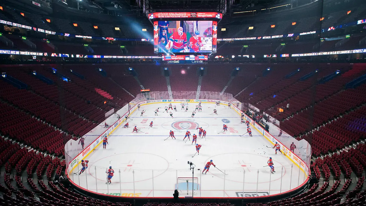New Jersey Devils and Montreal Canadiens warm up before an NHL hockey game in Montreal, Tuesday, Feb., 8, 2022. (Graham Hughes/The Canadian Press via AP)
