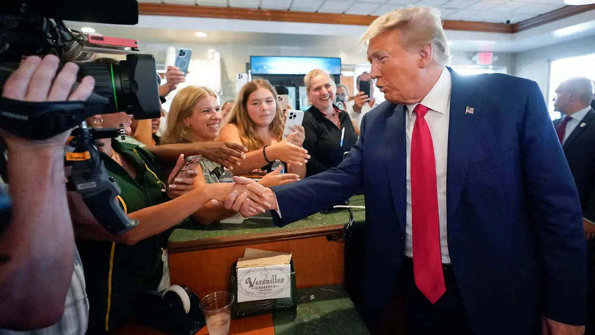 Former President Donald Trump greets supporters at Versailles restaurant on Tuesday, June 13, 2023, in Miami. Trump appeared in federal court Tuesday on dozens of felony charges accusing him of illegally hoarding classified documents and thwarting the Justice Department's efforts to get the records back. (AP Photo/Alex Brandon)