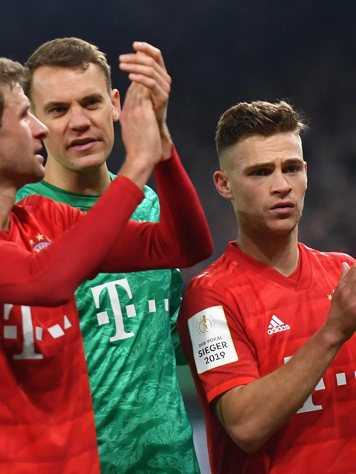 ARCHIV - 03.03.2020, Nordrhein-Westfalen, Gelsenkirchen: Fußball: DFB-Pokal, FC Schalke 04 - Bayern München, Viertelfinale in der Veltins Arena: Thomas Müller, Torhüter Manuel Neuer und Joshua Kimmich von Bayern nach dem Spiel. (zu dpa: «Bayern-Stars und Chefs verzichten auf 20 Prozent ihrer Gehälter») Foto: Bernd Thissen/dpa - WICHTIGER HINWEIS: Gemäß den Vorgaben der DFL Deutsche Fußball Liga bzw. des DFB Deutscher Fußball-Bund ist es untersagt, in dem Stadion und/oder vom Spiel angefertigte Fotoaufnahmen in Form von Sequenzbildern und/oder videoähnlichen Fotostrecken zu verwerten bzw. verwerten zu lassen. +++ dpa-Bildfunk +++