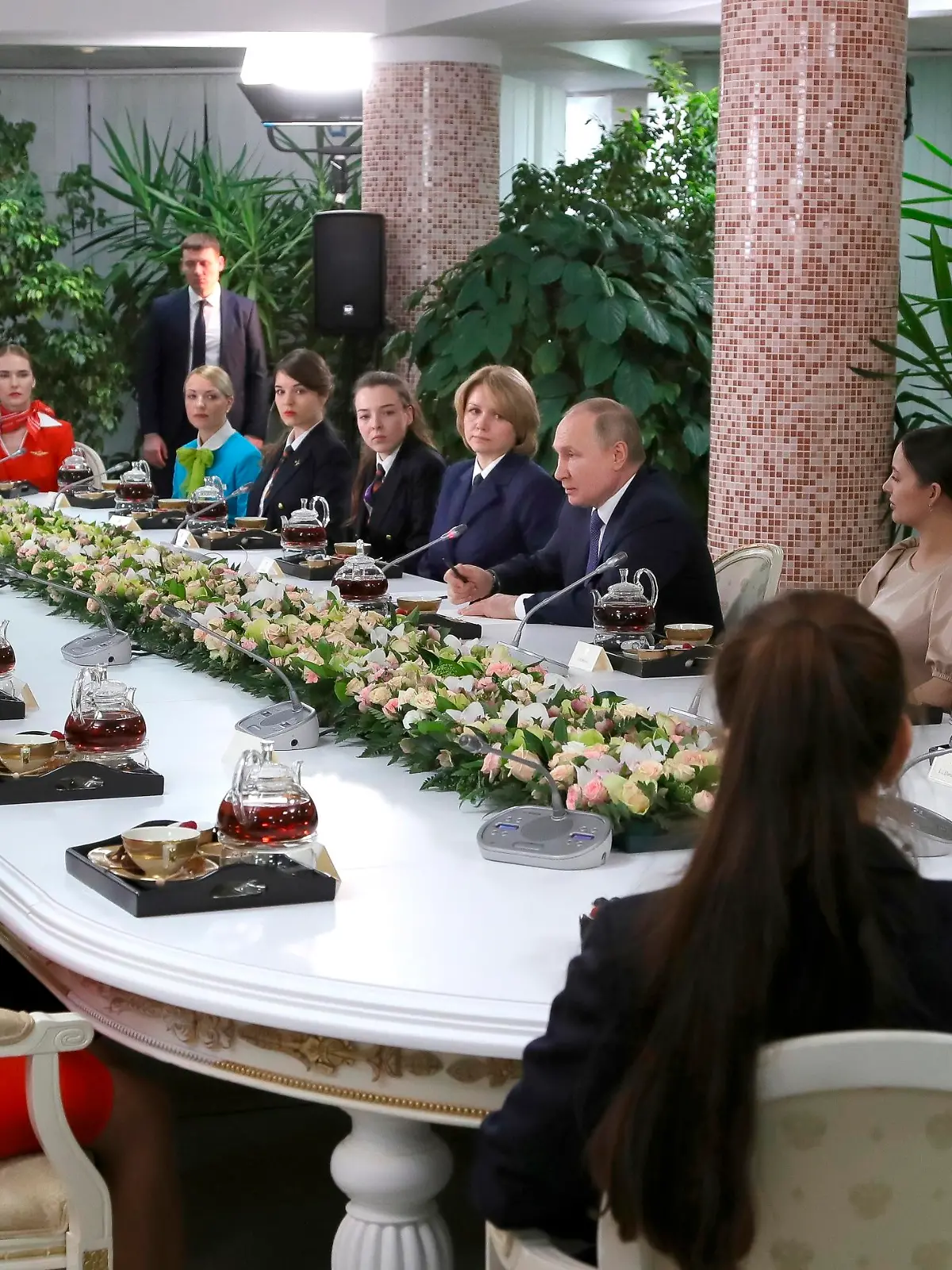 Russian President Vladimir Putin, center right, speaks to representatives of the flight crew of Russian airlines as he visits to Aeroflot Aviation School outside Moscow, Russia, Saturday, March 5, 2022. (, Sputnik, Kremlin Pool Photo via AP)