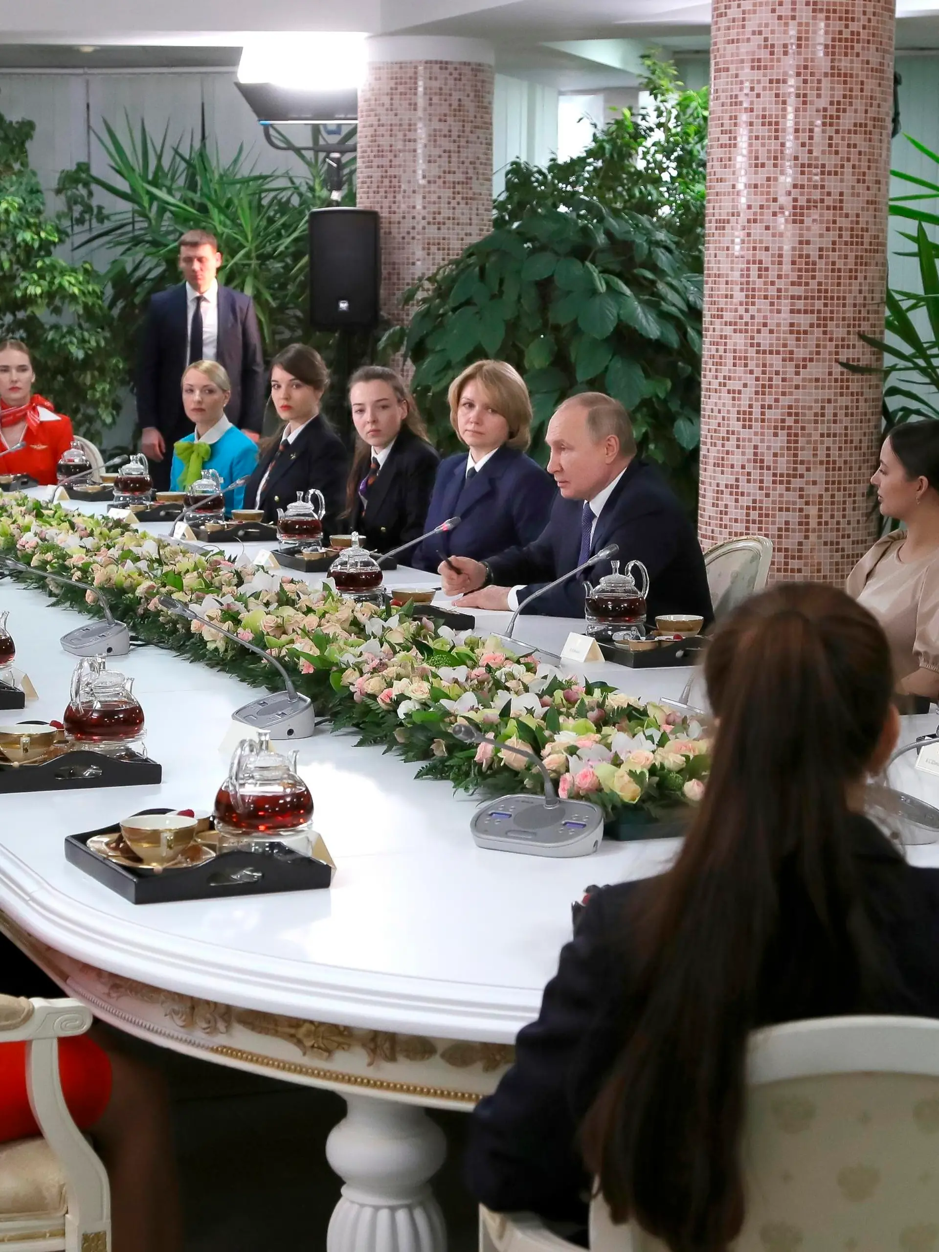 Russian President Vladimir Putin, center right, speaks to representatives of the flight crew of Russian airlines as he visits to Aeroflot Aviation School outside Moscow, Russia, Saturday, March 5, 2022. (, Sputnik, Kremlin Pool Photo via AP)