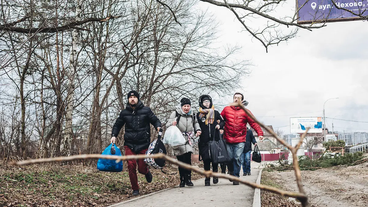 06.03.2022, Ukraine, Irpin: Eine Familie rennt vor dem Beschuss weg in Irpin, Ukraine. Die Waffenruhe, die für  Sonntag in der ukrainischen Stadt Irpin geplant war, um einen humanitären Korridor zu schaffen, ist gescheitert. Die russische Armee hat am Morgen einen Evakuierungspunkt für Zivilisten beschossen. Russische Truppen marschierten am 24. Februar in die Ukraine ein. Foto: Diego Herrera/EUROPA PRESS/dpa +++ dpa-Bildfunk +++