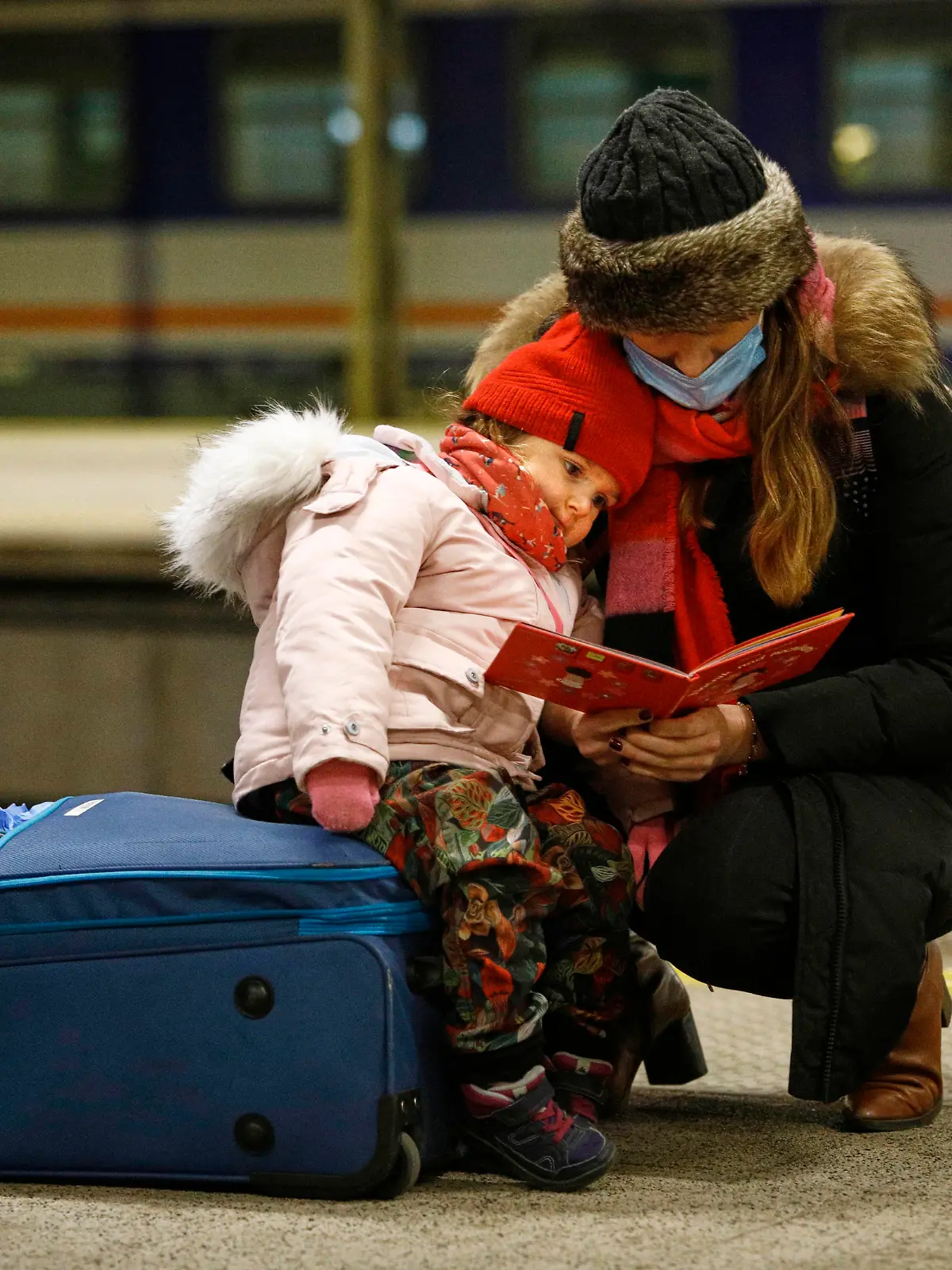 News Bilder des Tages Refugees From Ukraine Arrive In Warsaw A woman reads a book while holding a child after the arrival of a train with 350 refugees from Kyiv, Ukraine at the Warsaw East train station in Warsaw, Poland on 04 March, 2022. Every day several thousand refugees arrive in Warsaw train stations, fleeing the violence after Russia s invasion. Nearly one million people have fled Ukraine after the Russian invasion and approximately 700 thousand of those have fled to Poland. Thanks to a number of private and public initiatives and the efforts of local municipalities refugees from Ukraine have been received with open arms and enjoy shelter, free food and free transportation in Poland. Warsaw Poland PUBLICATIONxNOTxINxFRA Copyright: xSTRx originalFilename: arriens-refugees220304_np21i.jpg