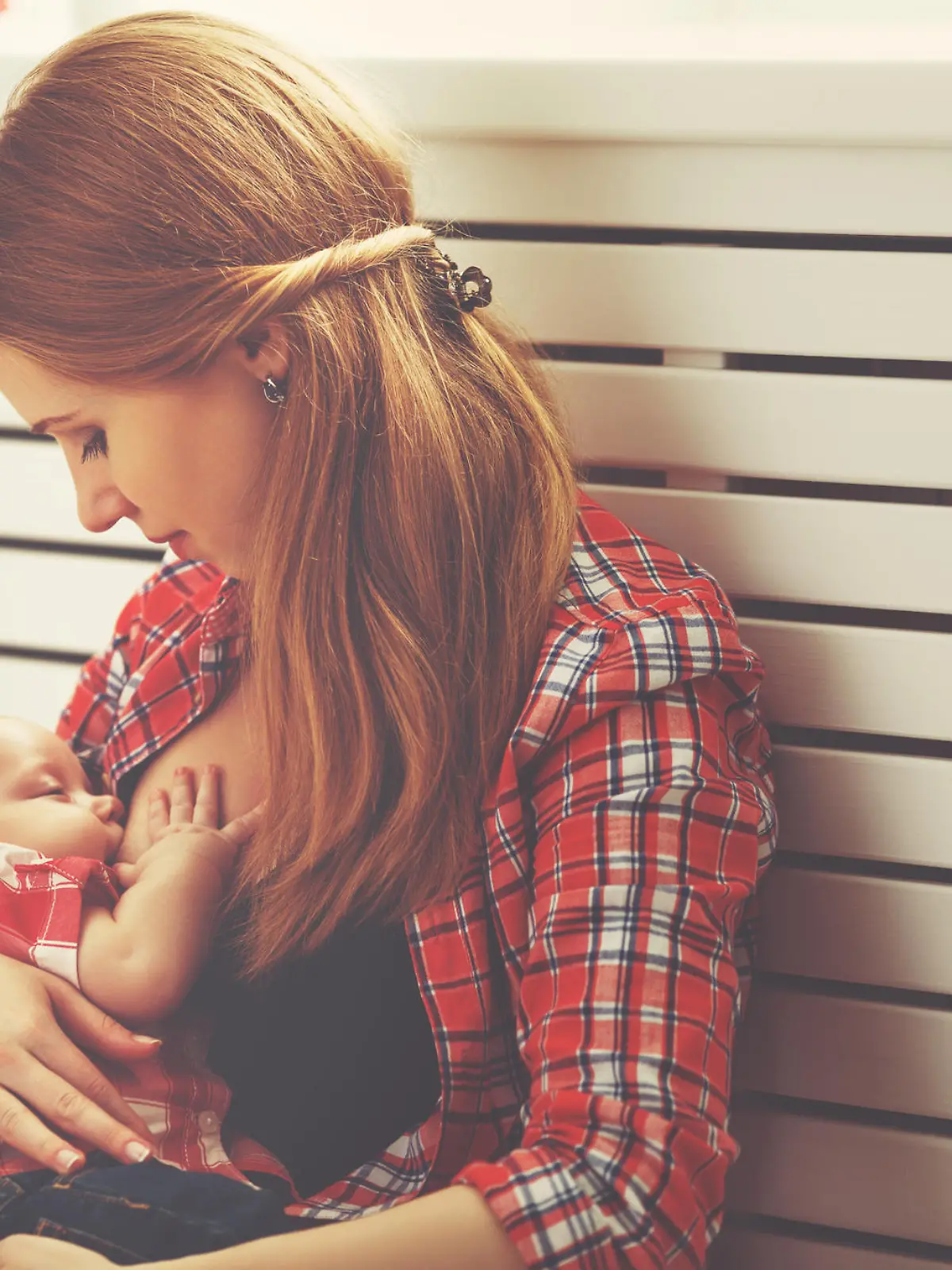 mother breast feeding her baby toddler