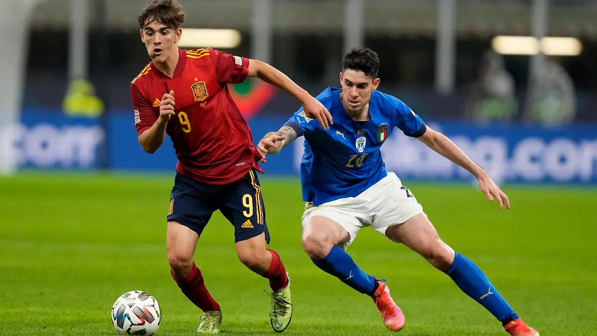 Spain's Gavi, left, and Italy's Alessandro Bastoni vie for the ball during the UEFA Nations League semifinal soccer match between Italy and Spain at the San Siro stadium, in Milan, Italy, Wednesday, Oct. 6, 2021. (AP Photo/Antonio Calanni)