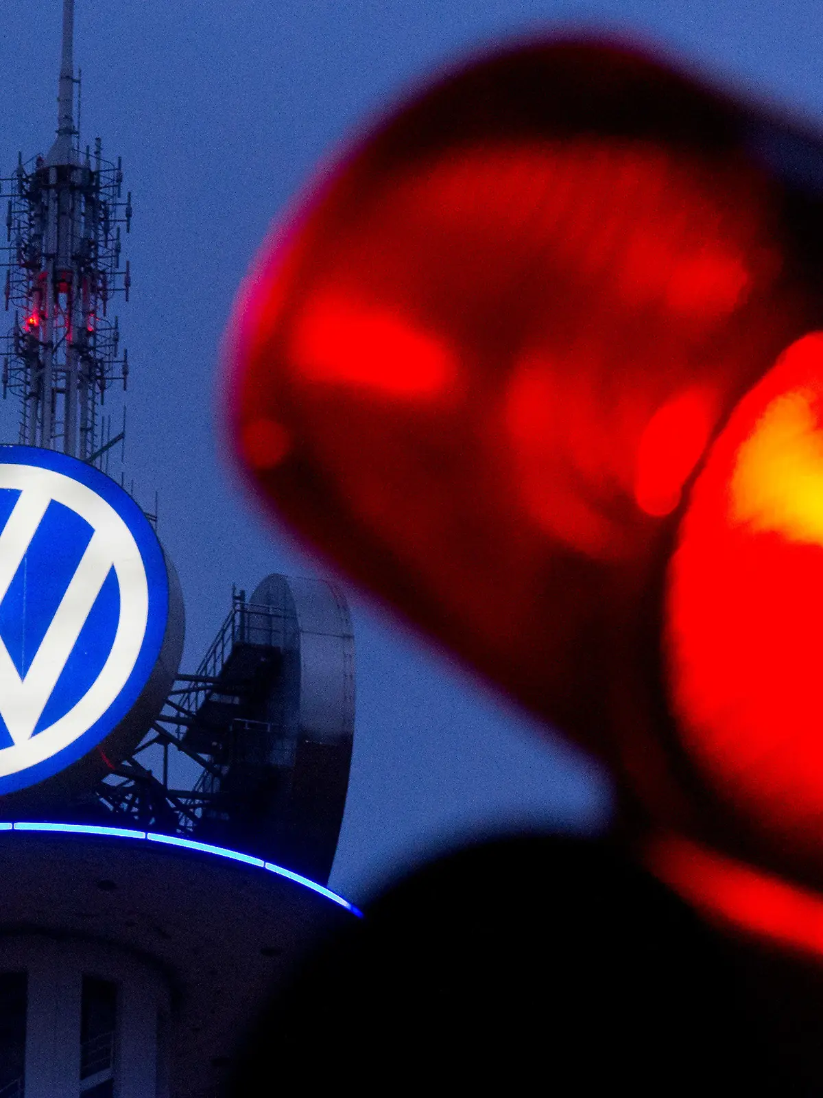 ARCHIV - Ein großes Logo von Volkswagen leuchtet am 04.02.2016 in der Morgendämmerung auf dem VW-Tower in Hannover (Niedersachsen) - fotografiert mit einer roten Ampel. Im Abgasskandal will Volkswagen die gerichtlich angeordnete Sonderprüfung Medienberichten zufolge in höchster Instanz verhindern. Foto: Julian Stratenschulte/dpa +++(c) dpa - Bildfunk+++