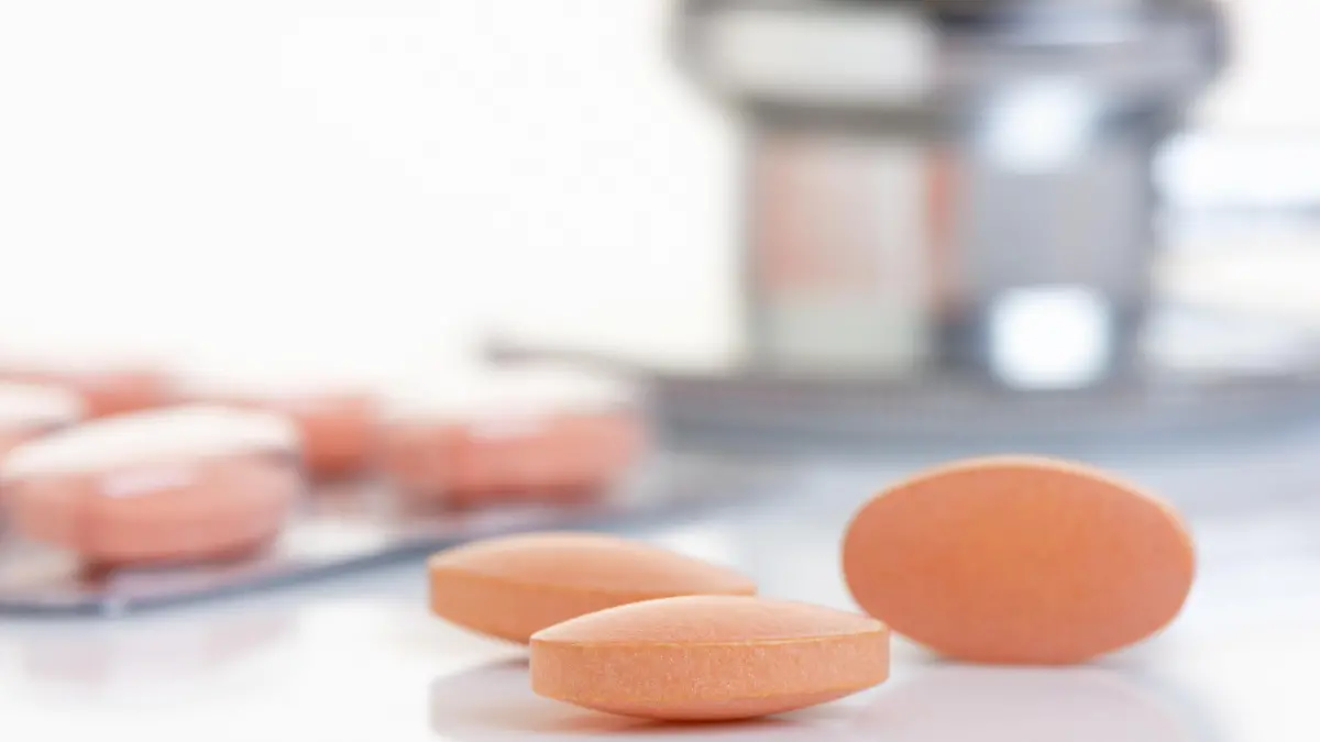Close up of a Statin tablet - the controversial cholesterol lowering drug.  Shallow d o f