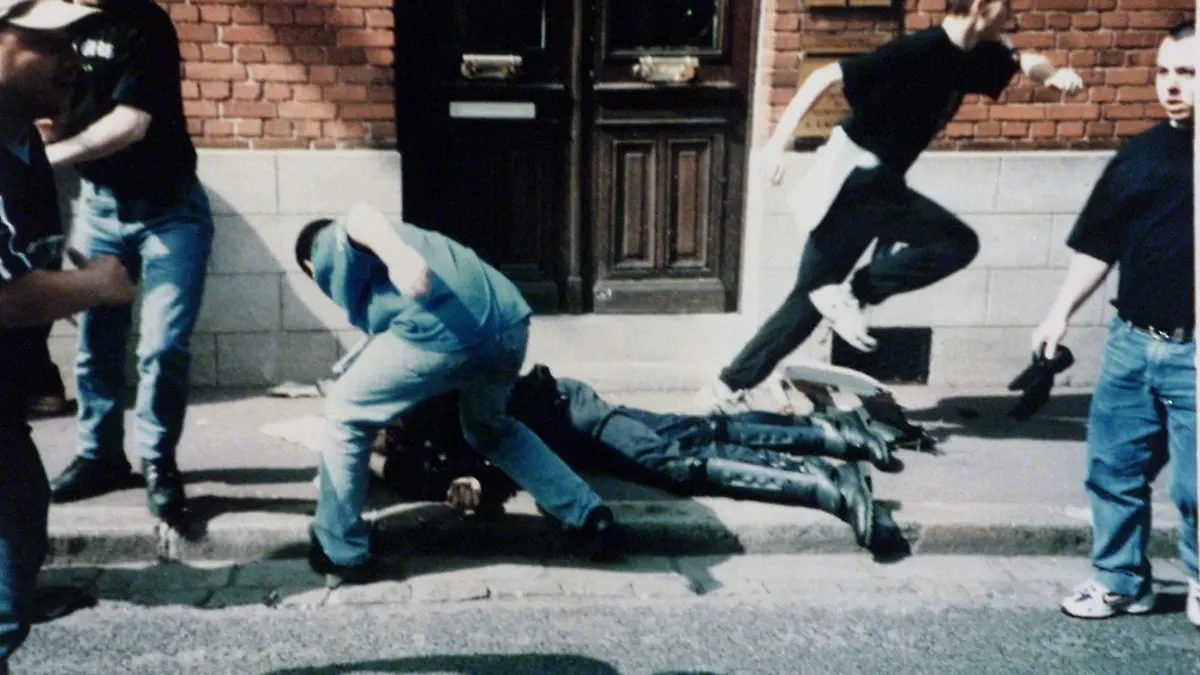 The Essen prosecuting attorney`s office hand out picture shows the moment as the 28-year-old German hooligan Andre Zawacki, center, tries to beat French police officer Daniel Nivel, lying on the ground, during Soccer World Cup in Lens, France, June 21, 1998. Accused 24-year-old Tobais Reifschlaeger escapes, rear right. Two of four German hooligans go to court on attempted murder and other charges in Essen, Thursday May 6,1999. The hooligan at right is unidentified. (AP Photo/handout /Essen prosecuting attorney`s office) **INTERNET OUT**