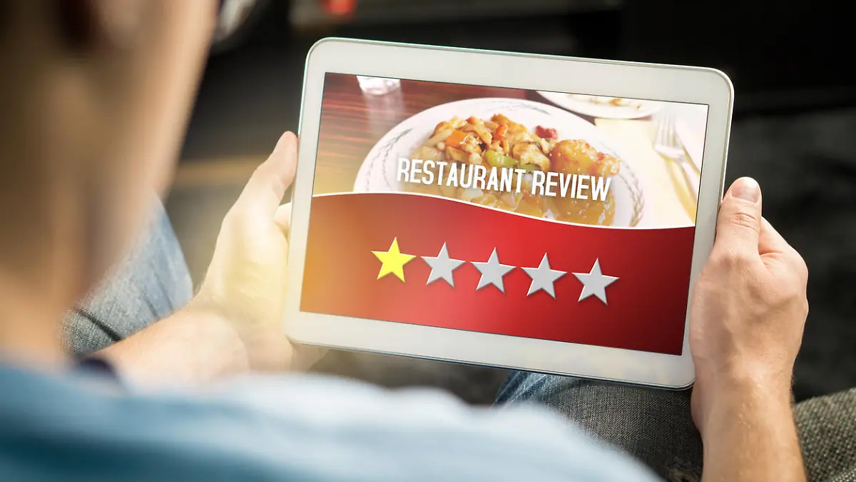 Bad restaurant review. Disappointed and dissatisfied customer giving terrible rating with tablet on an imaginary criticism site, application or website. Man giving one out of five stars at home.