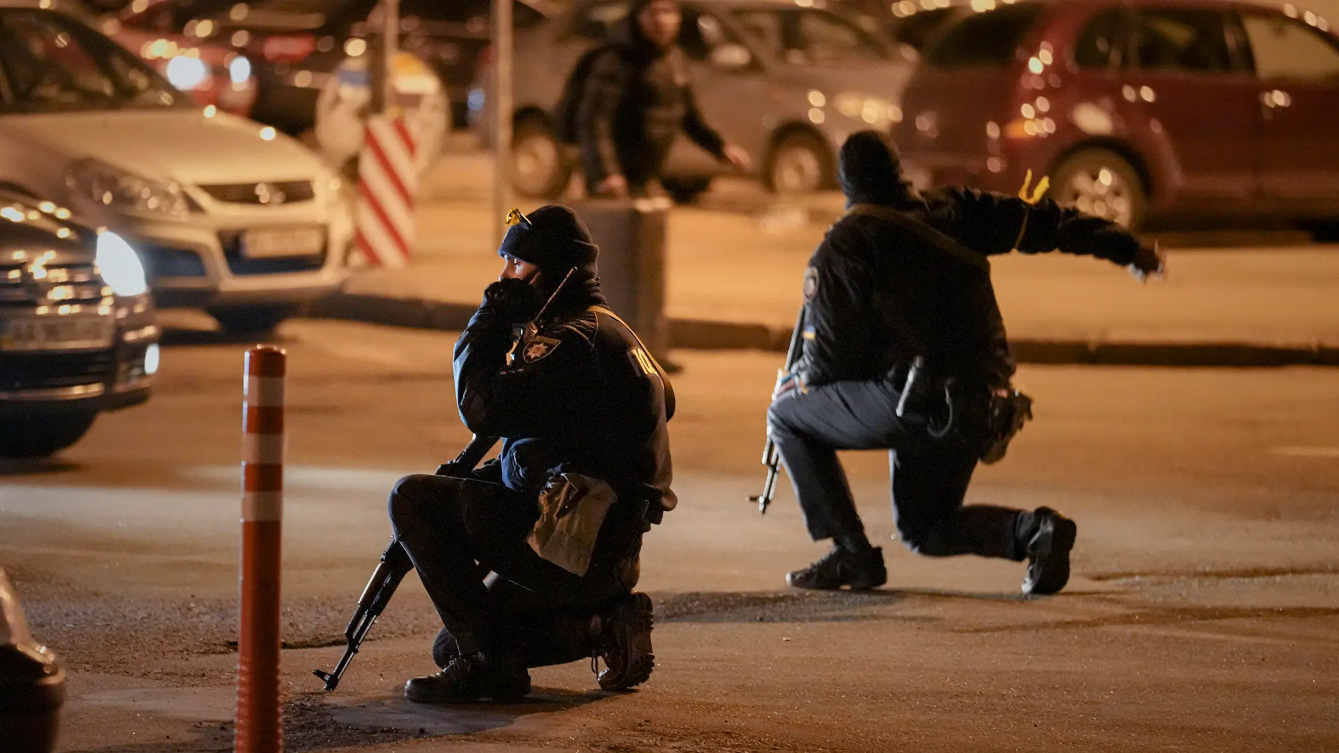 28.02.2022, Ukraine, Kiew: Ukrainische Polizisten wesien einen Reisenden während eines Luftalarms den Weg zum Bahnhofsterminal. Die Explosionen und Schüsse, die das Leben seit Beginn der Invasion in der vergangenen Woche gestört haben, schienen über Nacht in der Umgebung von Kiew nachzulassen, als sich ukrainische und russische Delegationen am Montag an der ukrainischen Grenze zu Weißrussland trafen. Foto: Vadim Ghirda/AP/dpa +++ dpa-Bildfunk +++