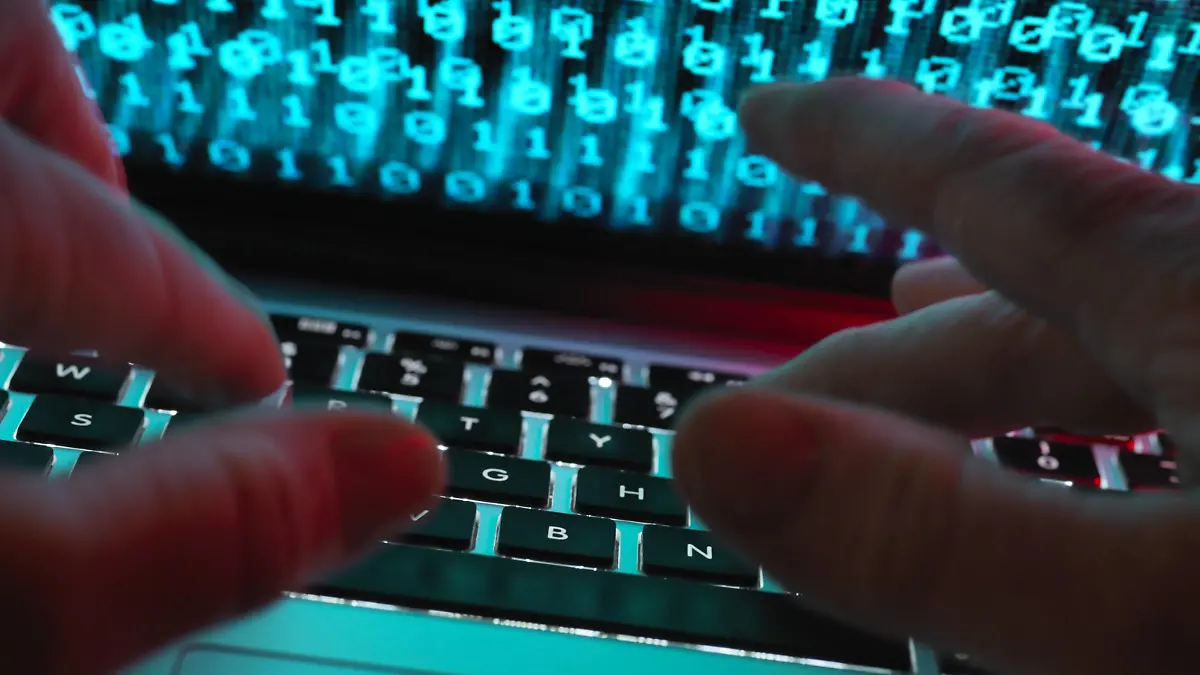  Hacker coding a computer virus infecting a laptop model released Symbolfoto property released PUBLICATIONxINxGERxSUIxAUTxHUNxONLY ABRF00346