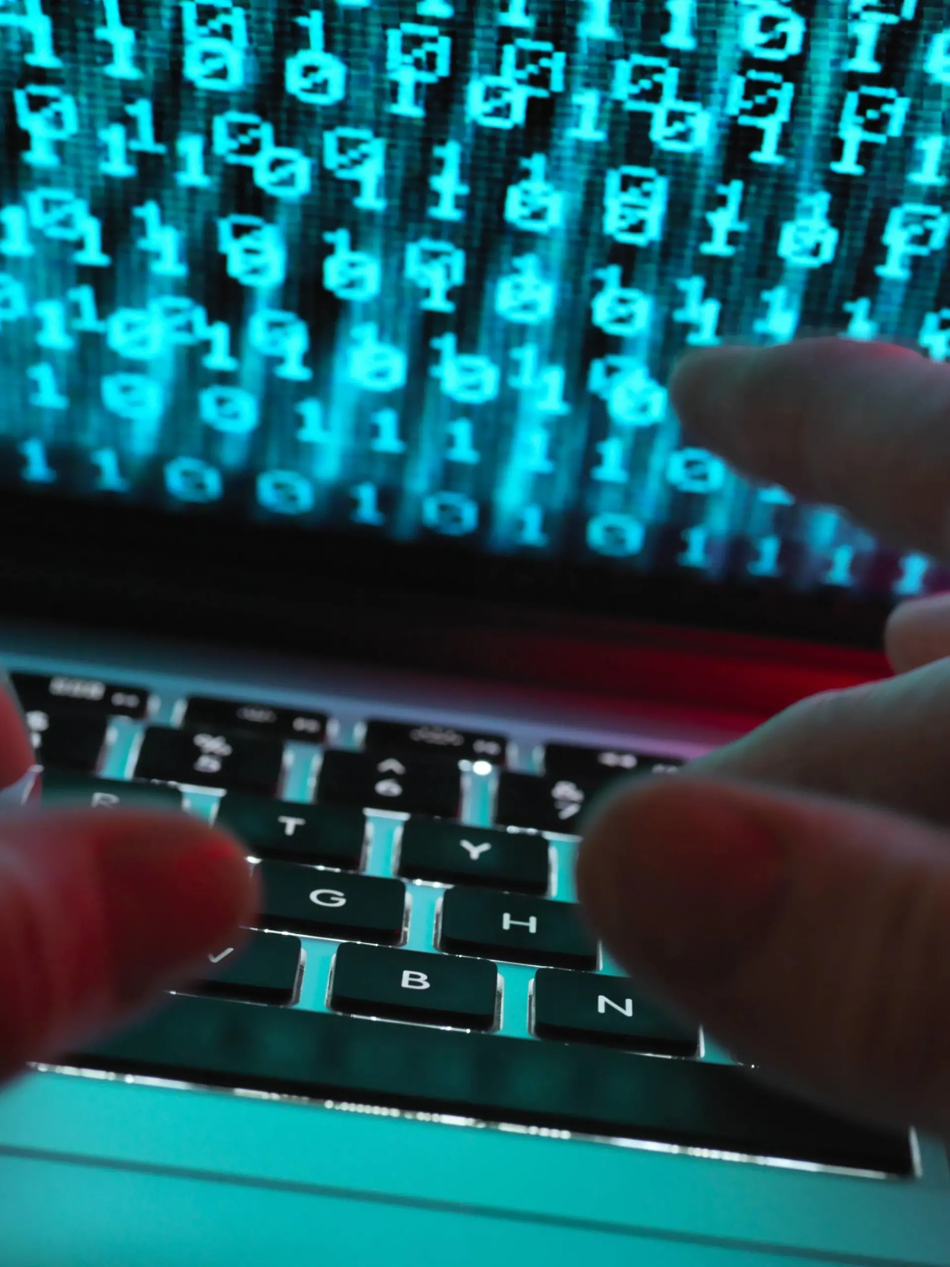  Hacker coding a computer virus infecting a laptop model released Symbolfoto property released PUBLICATIONxINxGERxSUIxAUTxHUNxONLY ABRF00346