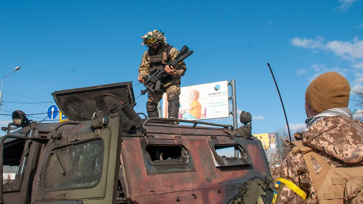 27.02.2022, Ukraine, Charkiw: Ukrainische Soldaten inspizieren ein beschädigtes Militärfahrzeug nach Kämpfen in Charkiw. Die ostukrainische Millionenstadt Charkiw ist nach Angaben des Gouverneurs wieder komplett in ukrainischer Hand. Foto: Marienko Andrew/AP/dpa +++ dpa-Bildfunk +++