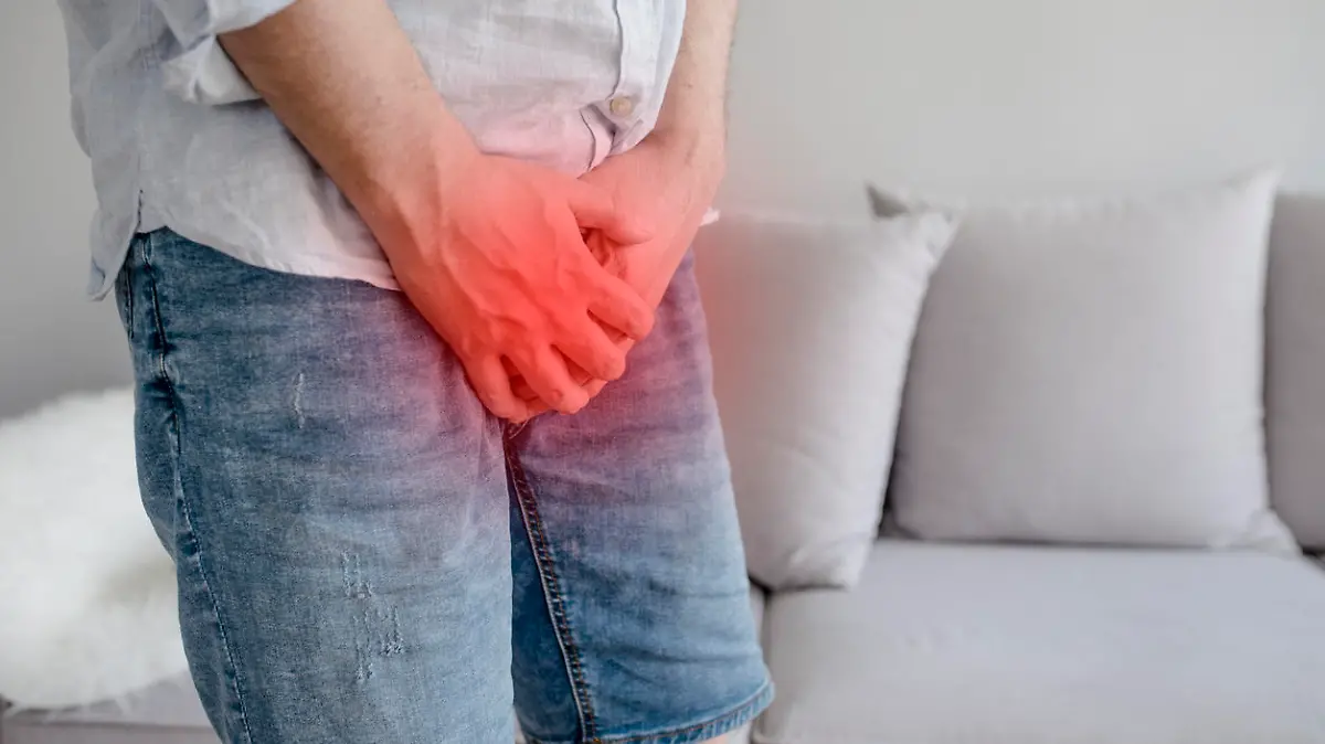 Close up young man holding his genitals cause pain, prostate cancer, premature, ejaculation, fertility, bladder problem. Man hand holding on middle crotch of trousers