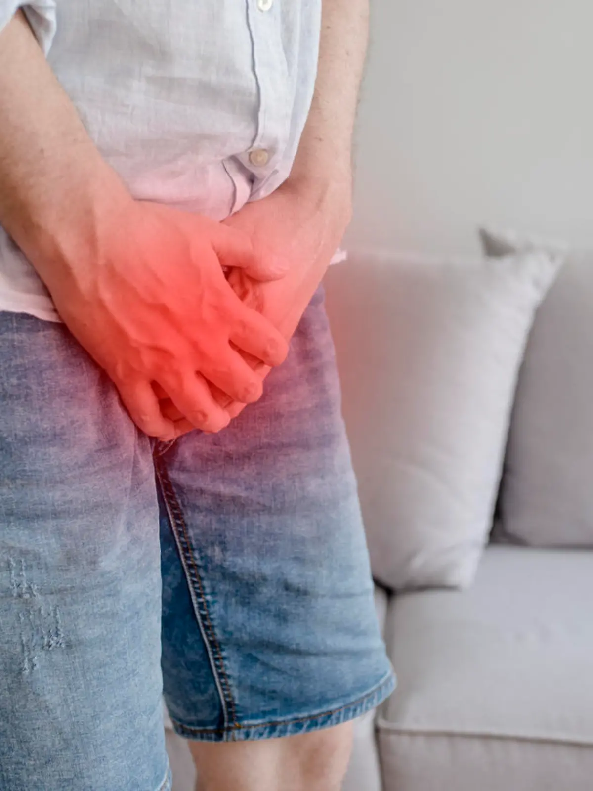 Close up young man holding his genitals cause pain, prostate cancer, premature, ejaculation, fertility, bladder problem. Man hand holding on middle crotch of trousers