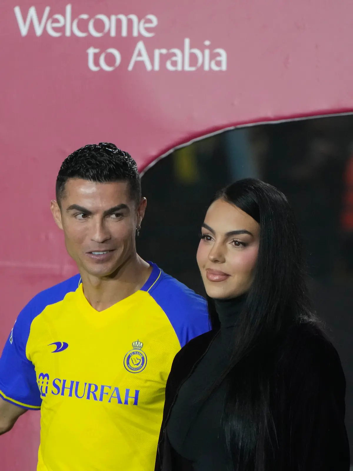 Cristiano Ronaldo looks at Georgina Rodriguez as they attend the official unveiling as a new member of Al Nassr soccer club in in Riyadh, Saudi Arabia, Tuesday, Jan. 3, 2023. Ronaldo, who has won five Ballon d'Ors awards for the best soccer player in the world and five Champions League titles, will play outside of Europe for the first time in his storied career. (AP Photo/Amr Nabil)