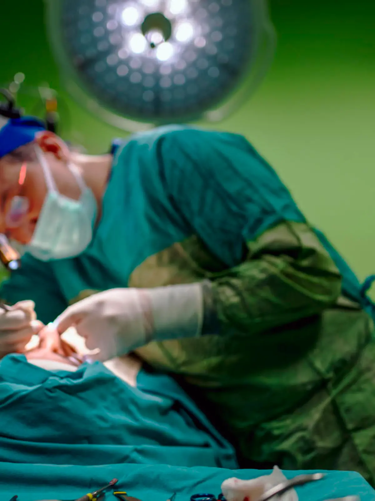 Young male plastic surgeon operates in the operating room of a medical center