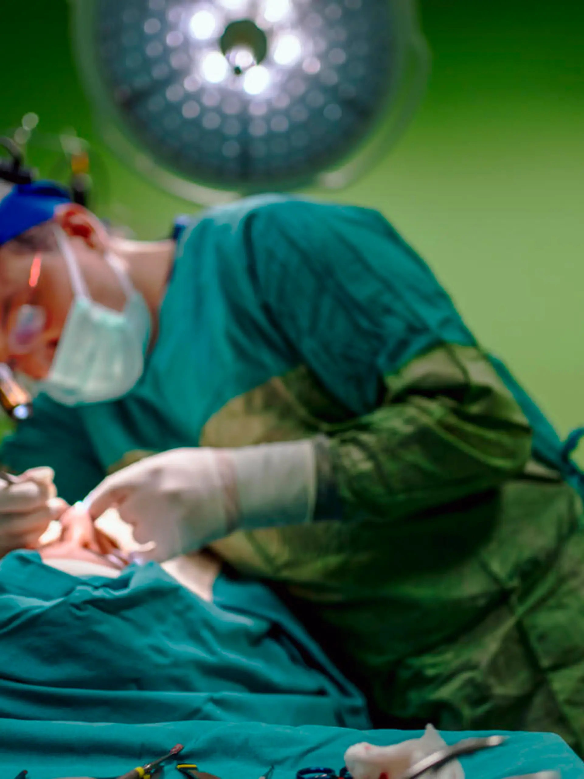 Young male plastic surgeon operates in the operating room of a medical center