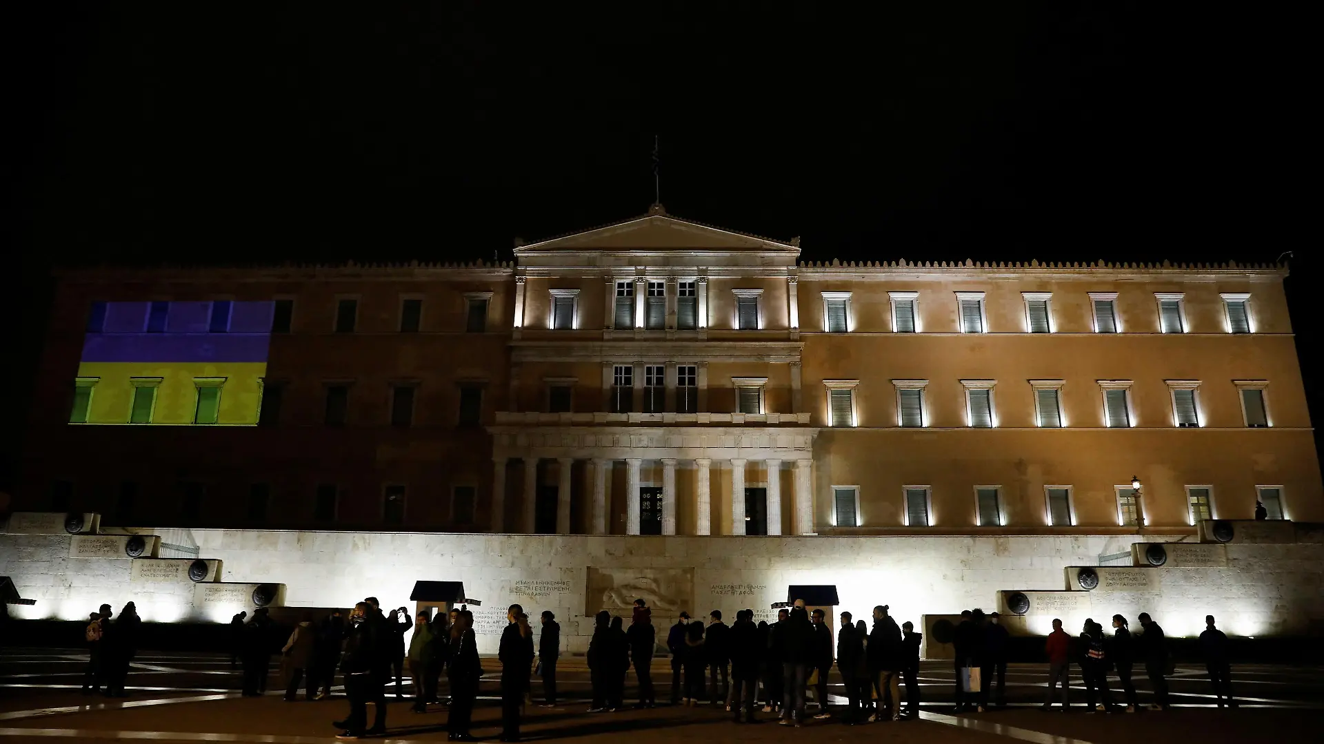 The colours of the Ukrainian flag are projected on the facade of the parliament building in support of the Ukrainian people after Russia launched a massive military operation against Ukraine, in Athens, Greece, February 26, 2022. REUTERS/Costas Baltas