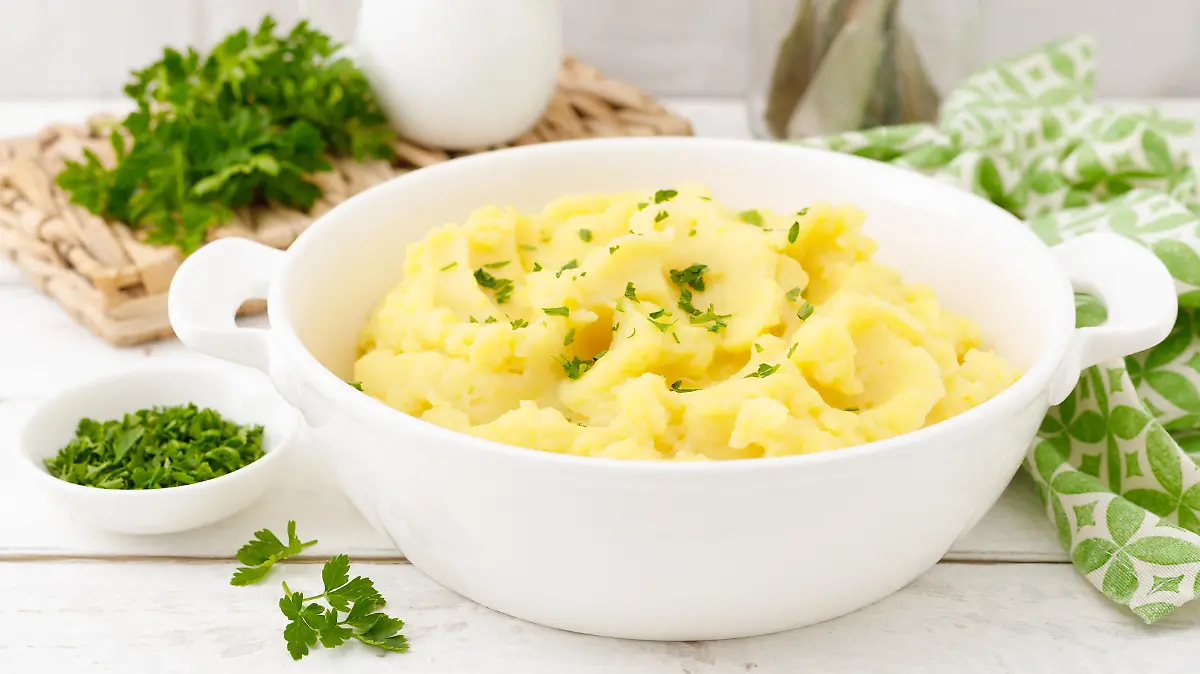 Mashed potato with butter and milk on table