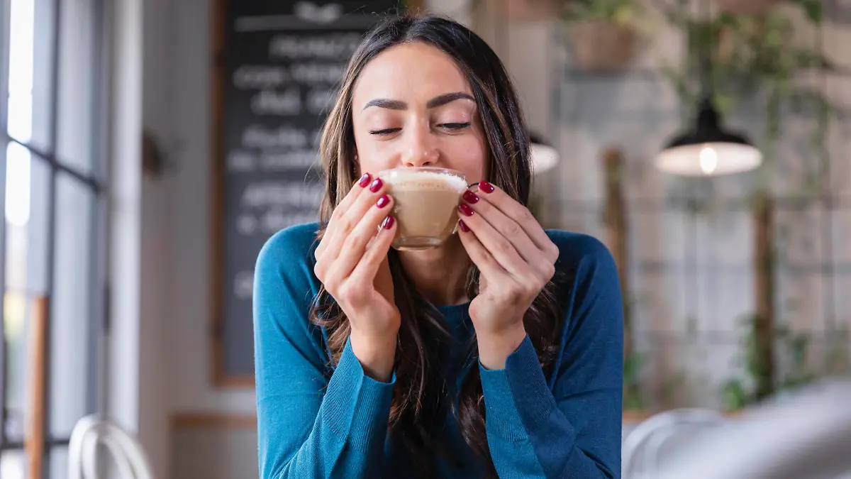 Happy woman drinking cappuccino in coffee shop model released property released, EIF03210