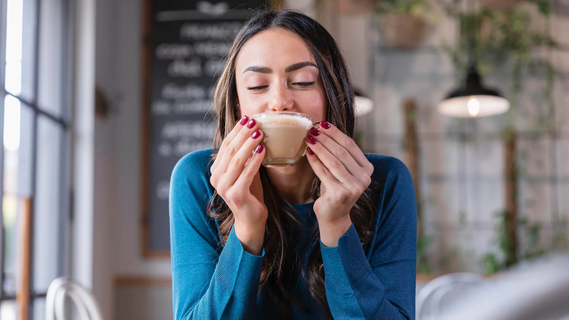 Happy woman drinking cappuccino in coffee shop model released property released, EIF03210