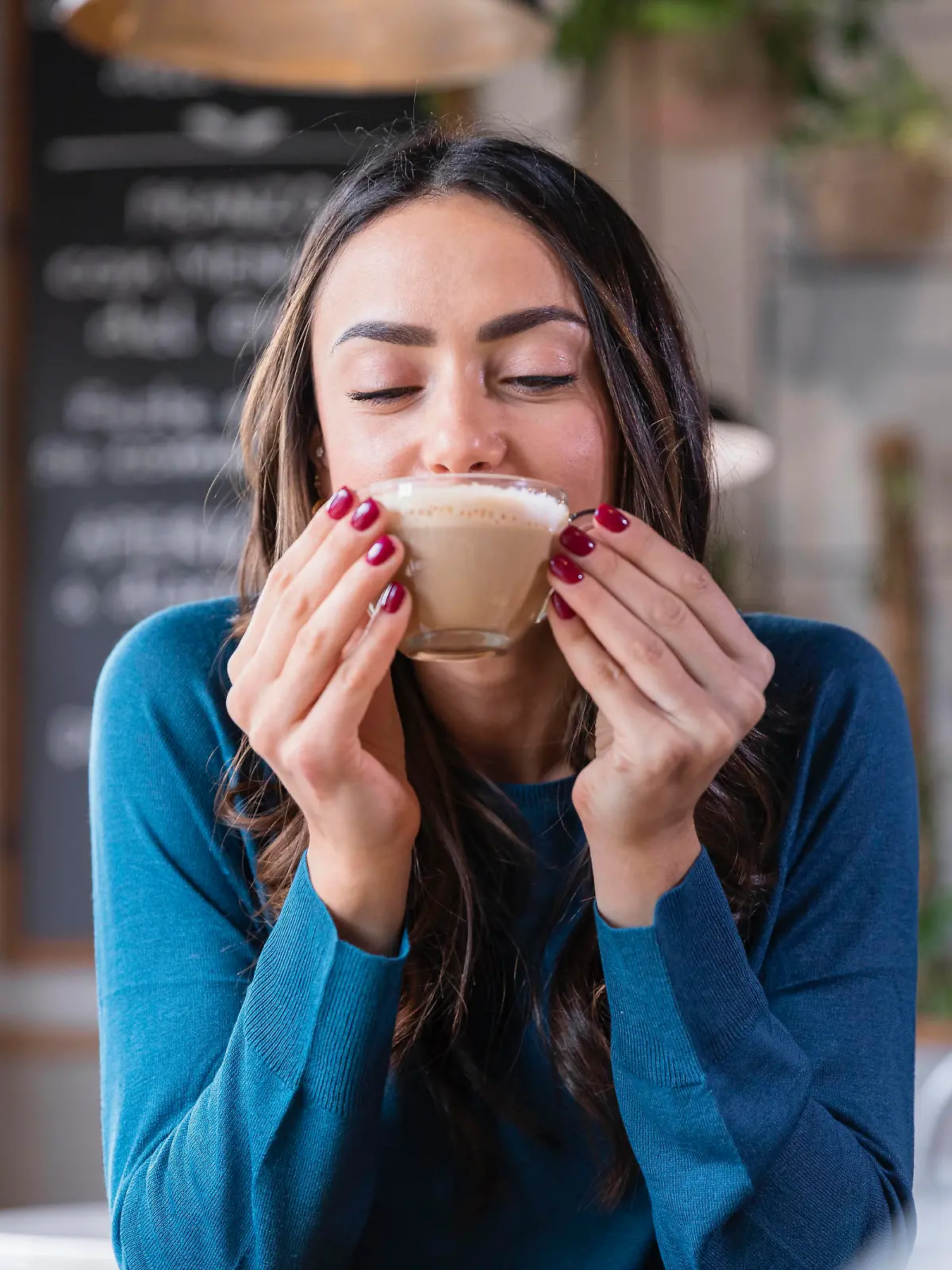 Happy woman drinking cappuccino in coffee shop model released property released, EIF03210