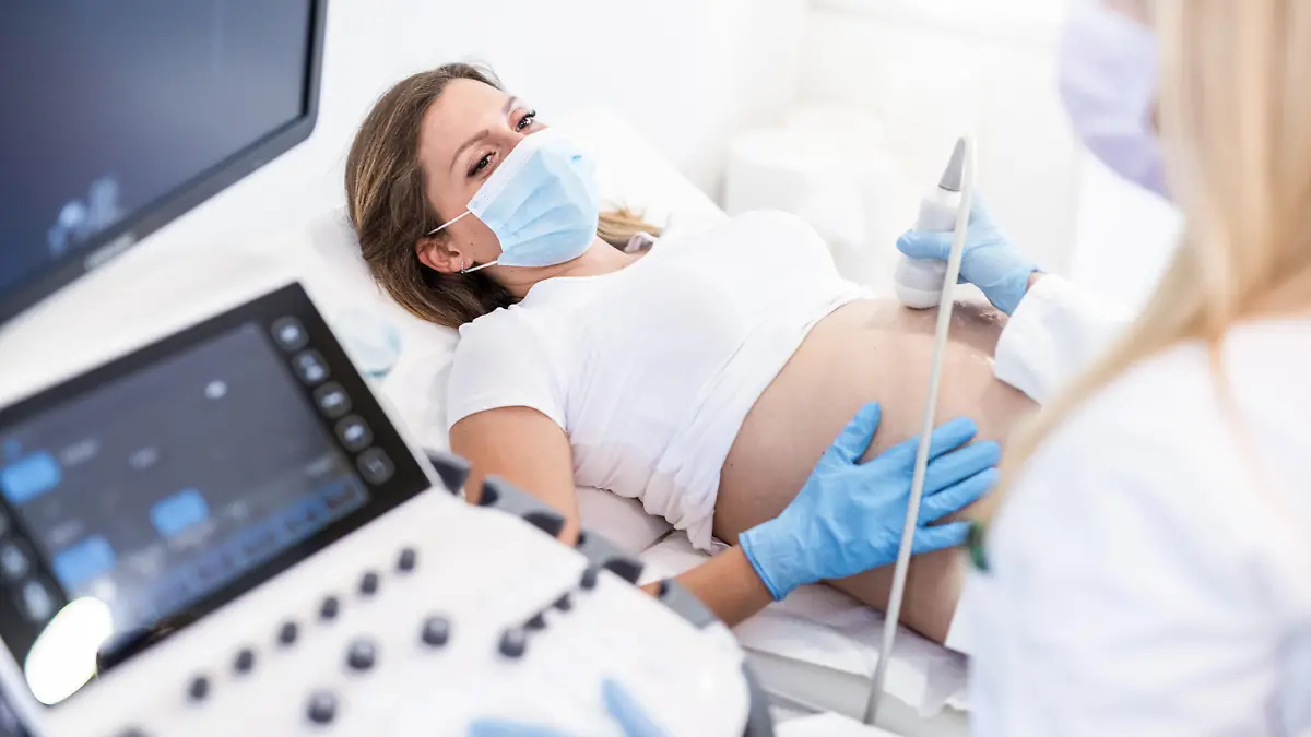 Ultrasound pregnancy examination of young woman in a Medical Clinic during Covid 19 outbreak.