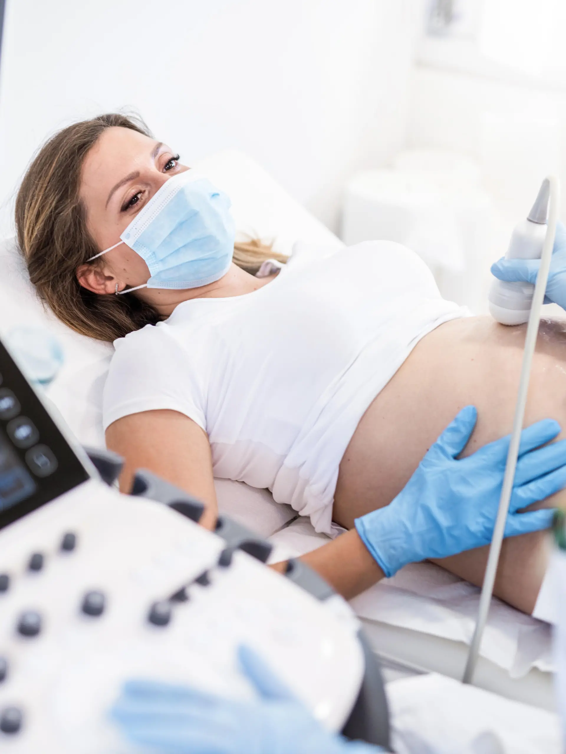Ultrasound pregnancy examination of young woman in a Medical Clinic during Covid 19 outbreak.