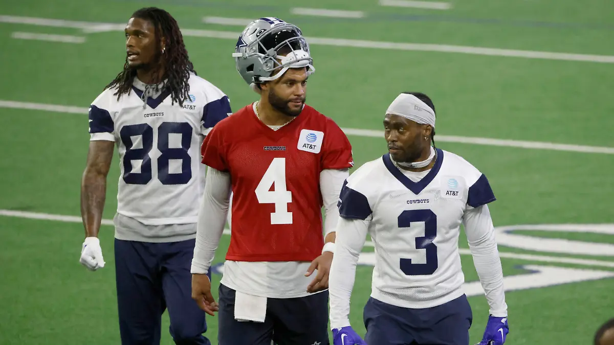 Dallas Cowboys wide receiver CeeDee Lamb (88), quarterback Dak Prescott (4) and wide receiver Brandin Cooks (3) walk off the field during NFL football practice at the team's training facility in Frisco, Texas, Thursday, May 25, 2023. (AP Photo/Michael Ainsworth)