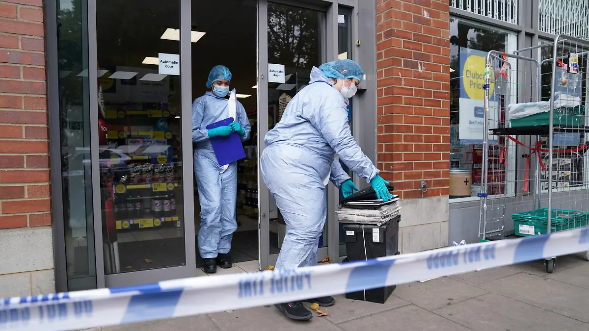 Supermarket food contaminated with syringes. Police officers in forensic suits outside Tesco Express on Fulham Palace Road, west London, which has been closed and a crime scene put in place after a man was arrested on suspicion of contaminating food with a syringe. Police were called on Wednesday evening to a man shouting abuse at people in the street and three supermarkets Tesco Express, Little Waitrose and Sainsbury's Local - have been closed for investigation. Picture date: Thursday August 26, 2021. See PA story POLICE Syringe . Photo credit should read: Jonathan Brady/PA Wire URN:61976487