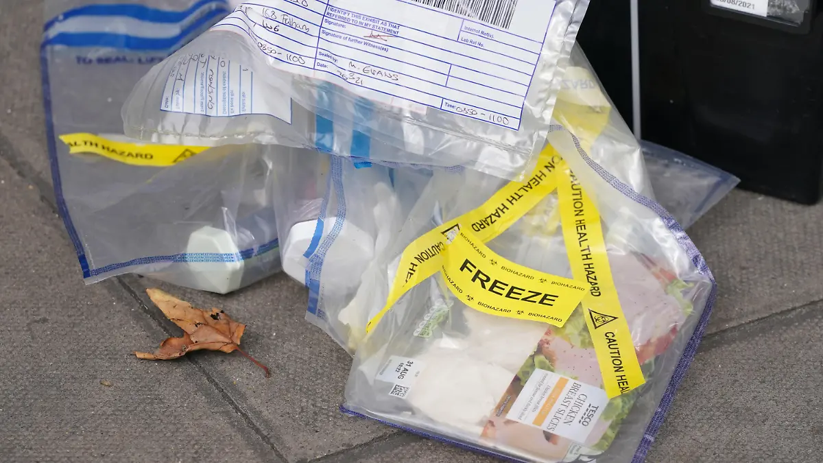 Supermarket food contaminated with syringes. Evidence bags marked as a health hazard and containing produce outside the Tescoe Express store on Fulham Palace Road, west London, which has been closed and a crime scene put in place after a man was arrested on suspicion of contaminating food with a syringe. Police were called on Wednesday evening to a man shouting abuse at people in the street and three supermarkets Tesco Express, Little Waitrose and Sainsbury's Local - have been closed for investigation. Picture date: Thursday August 26, 2021. See PA story POLICE Syringe . Photo credit should read: Jonathan Brady/PA Wire URN:61976545
