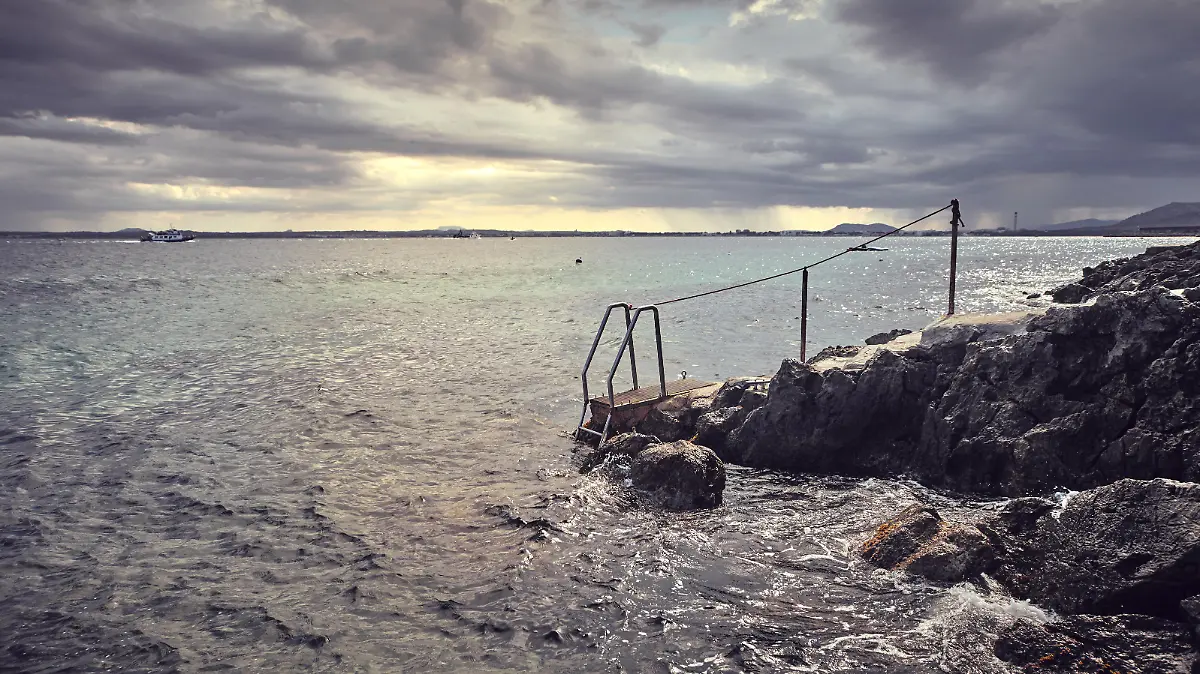 Path ended with sea ladder at sunset, color toning applied, Mallorca, Spain.