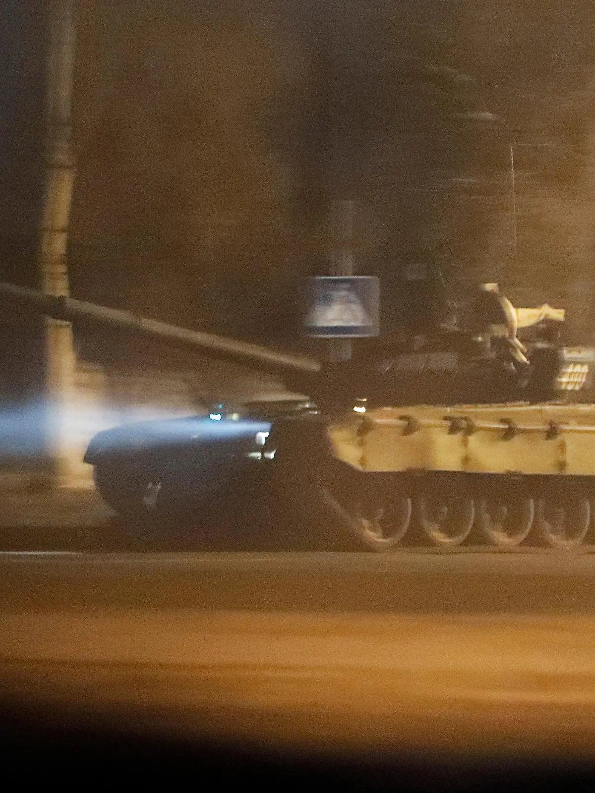 A tank drives along a street after Russian President Vladimir Putin ordered the deployment of Russian troops to two breakaway regions in eastern Ukraine following the recognition of their independence, in the separatist-controlled city of Donetsk, Ukraine February 22, 2022. REUTERS/Alexander Ermochenko