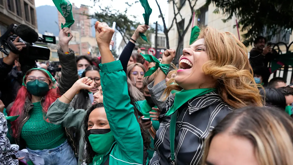 Abortion-rights activists celebrate after the Constitutional Court approved the decriminalization of abortion, lifting all limitations on the procedure until the 24th week of pregnancy, in Bogota, Colombia, Monday, Feb. 21, 2022. (AP Photo/Fernando Vergara)