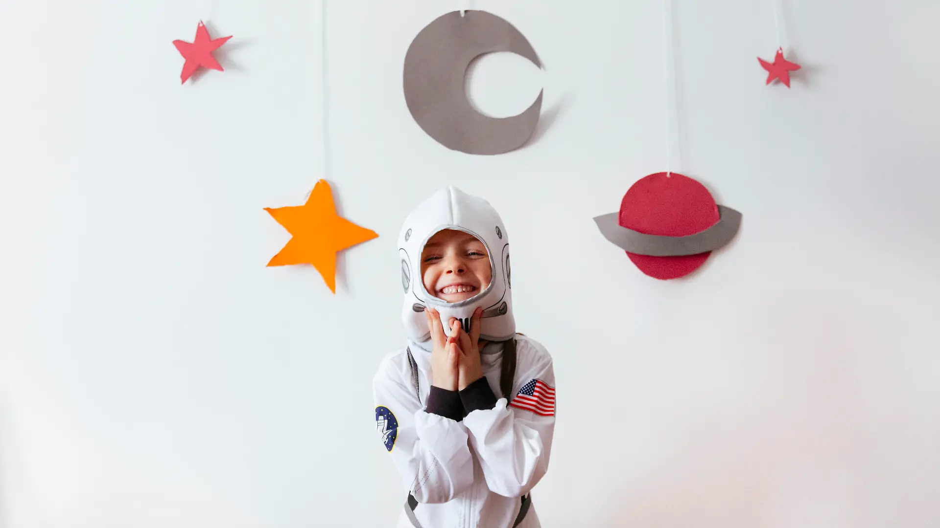 little girl with an astronaut costume at home