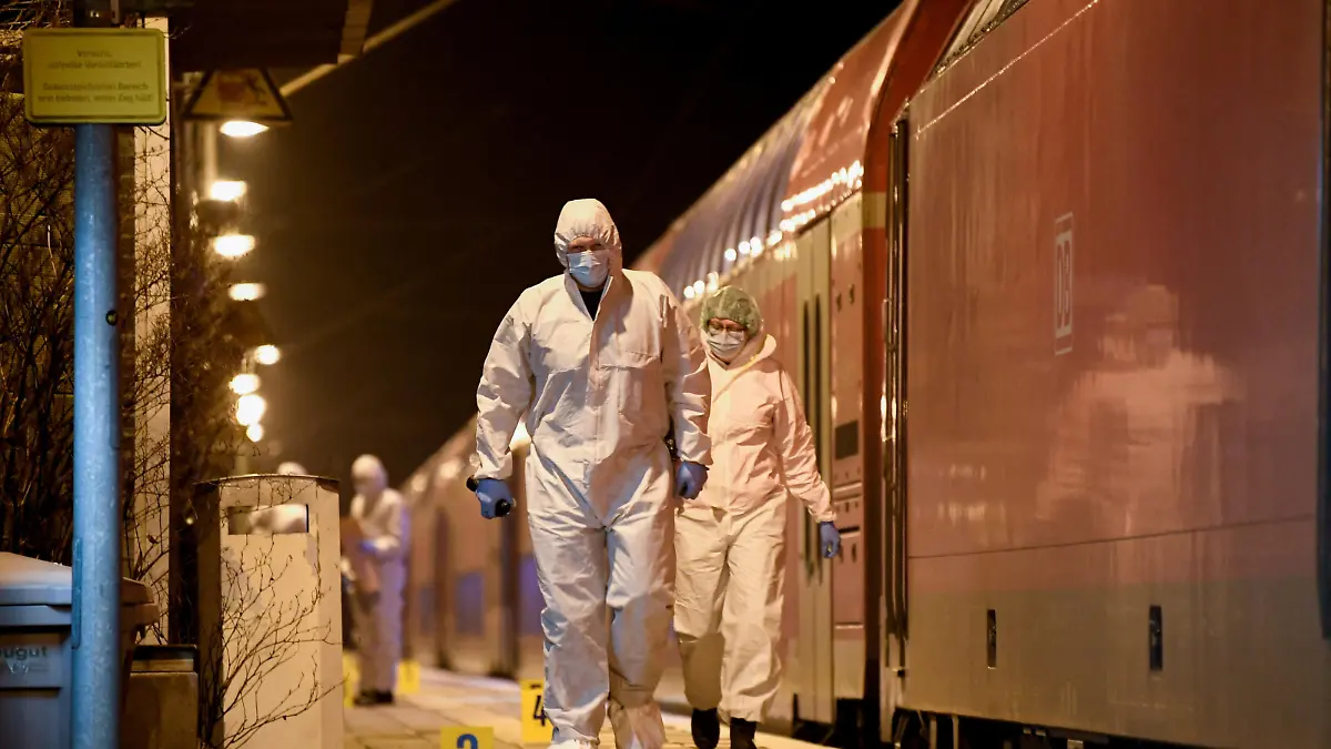 Forensic experts walk next to a train on which an incident involving a knife attack took place, at a railway station in Brokstedt, Germany, January 25, 2023. REUTERS/Fabian Bimmer TPX IMAGES OF THE DAY