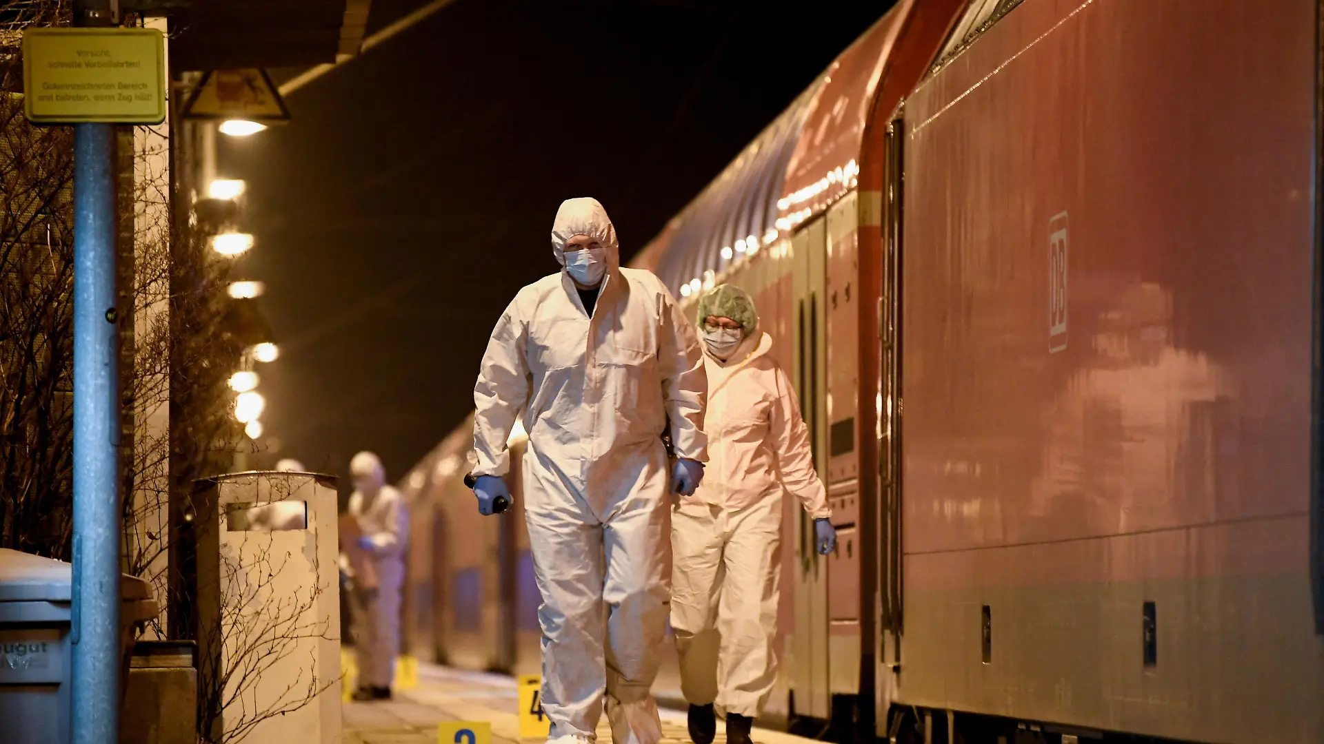 Forensic experts walk next to a train on which an incident involving a knife attack took place, at a railway station in Brokstedt, Germany, January 25, 2023. REUTERS/Fabian Bimmer TPX IMAGES OF THE DAY