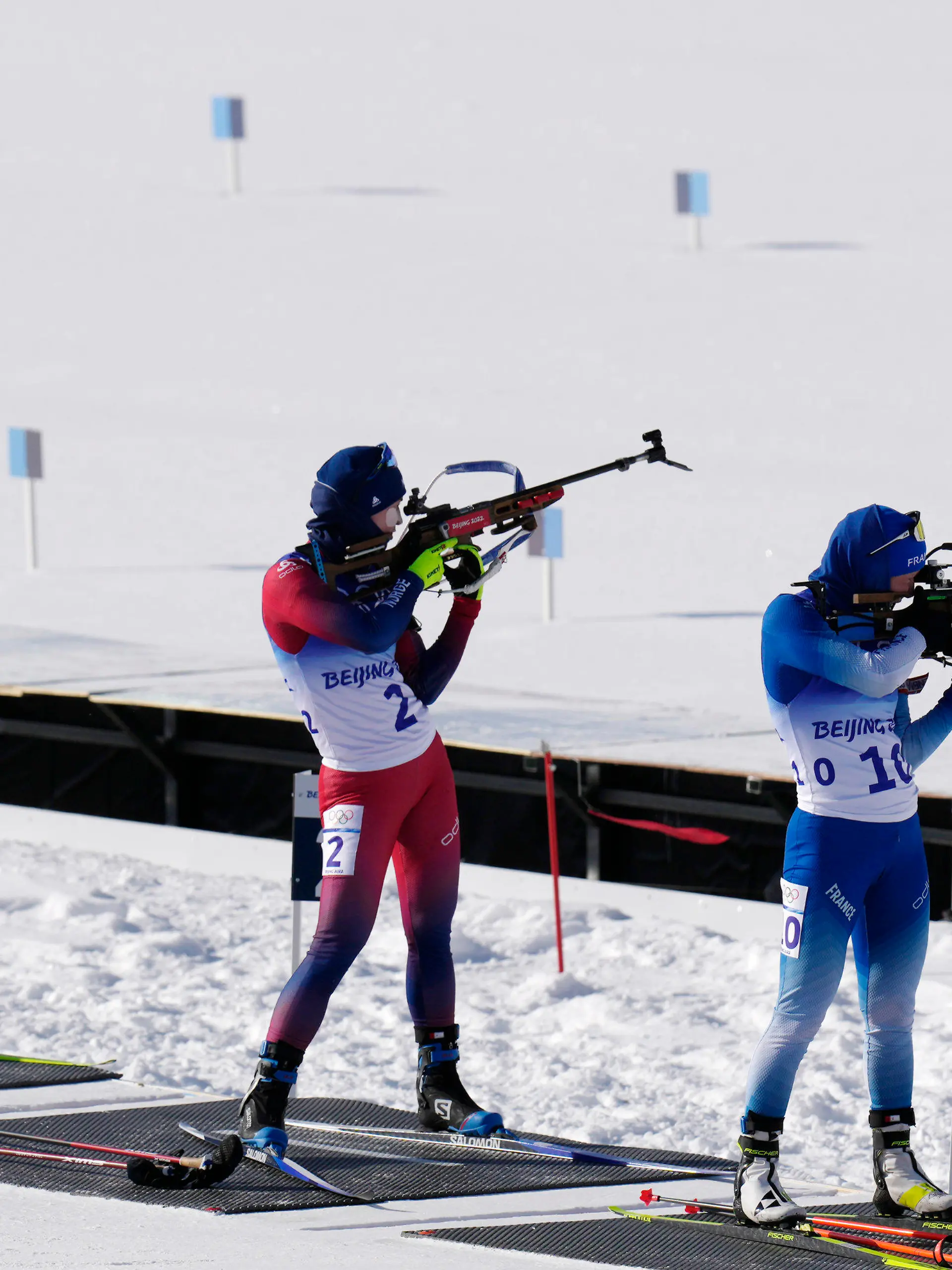 Justine Braisaz-Bouchet of France, right, shoots during the women's 12.5-kilometer mass start biathlon at the 2022 Winter Olympics, Friday, Feb. 18, 2022, in Zhangjiakou, China. (AP Photo/Kirsty Wigglesworth)